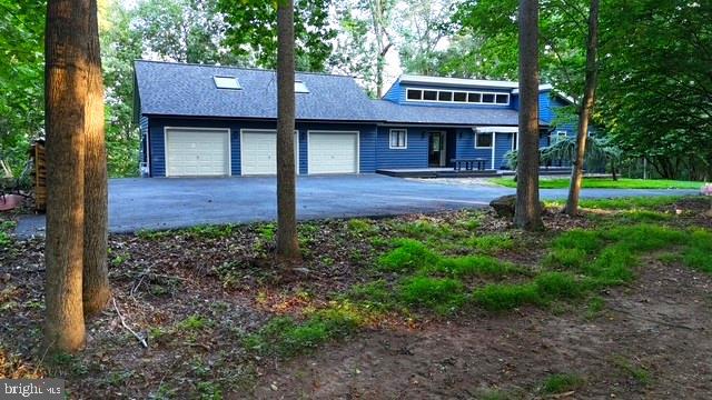 If you want privacy, seclusion and a water view then this contemporary perched 170 feet above the Potomac River is what you have been waiting for. Situated on a little over 5, partially deforested acres in the sought after Whitings Neck Farm Estates, this property has the perfect blend of comfort meets nature. As soon as you walk in the front door your eyes go directly to the water views and the large expansive deck. But don't get distracted by the views and miss the other wonderful features of this home. Total of four bedrooms and four bathrooms with two bedrooms and two bathrooms being on the main level for convenience. The primary bedroom features two walk in closets and a large well appointed bath with a skylight to add natural light. The main level kitchen, dining and living area is open floor plan perfect for entertaining. Cozy wood burning fireplace in the living area with pre-cut firewood that conveys. The laundry is on the main level as well for ease of use. Downstairs there are another two bedrooms and two bathrooms. Every bedroom can have their own bathroom in this charmer. This level has an expansive living area with ceramic tile floors, wet bar area and a bonus room for a home office, work out room or the unexpected house guest. Newly replaced sliders open to large concrete patio area on the lower level that mimics the size of the deck on the main level. Recently replaced roof, newly painted exterior and a new Geo-thermal Environmental system installed this month. To top it off this home features a massive three garage with a walk up attic storage area. Close to the Interstate, Martinsburg, Shepherdstown and minutes from the Maryland line. DC is just an hour and a half away from this one of a kind property. Make your appointment today! Photographs of the house and the common, private recreational area to come.