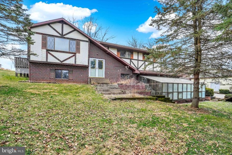 Thank you for taking the time to view 115 Hillstream Road, Red Lion, PA. This split-foyer home sits on a beautiful lot of just over two acres, set back from the road to provide a nice sense of privacy. The home was built with 2x6 construction and offers three bedrooms and three full baths. The upper level features a living room, kitchen, and dining area, while the lower level includes a family room, laundry area, and access to the two-car garage. A rear deck provides additional outdoor space and just needs a bit of TLC. One of the standout features of the property is the large 20 x 49 workshop, which is fully insulated in both the walls and ceiling and has its own separate electric meter. There is also a large detached shed for additional storage. The property includes two sizable ponds, perfect for fishing or simply enjoying the peaceful outdoor setting right in your own front yard.  The home is connected to public sewer, and there is a well located at the rear of the property that has a red cap on it. The roof was installed in 2011 and it is a 40 year shingle. A greenhouse addition was built onto the front of the home, offering a great space for those who enjoy gardening and want to extend their growing season.  With its acreage, ponds, outbuildings, and private setting, this property offers a unique opportunity in a great Red Lion location....no HOA, just you, buildings, ponds, and nature!