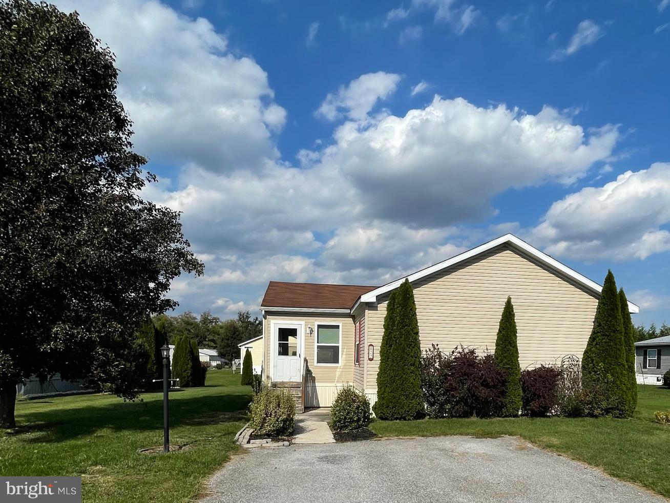Located in a Small Country Development of Maizefield is this Gorgeous 3 Bedroom Home with a Bonus Room (Office or additional Bedroom). The added enclosed porch with cathedral ceiling has endless possibilities for year-round use. The Primary Bedroom has a large bathroom with double vanities, stand up shower and a sunken tub. The Living/Dining/Kitchen area has a very open floor plan with plenty of counter and cabinet space. Located in the bonus room are pull down steps for additional attic storage space, not to mention the shed allows for outdoor storage as well. Lot rent covers sewer and trash. Schedule Your Private Tour Today - Must Be Park Approved!