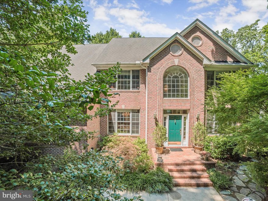 Welcome to your serene and secluded wooded retreat nestled in this picturesque water-privileged community off Joyce Lane. This elegant brick colonial home, situated on 2.02 acres of lush, forested land, offers a perfect blend of tranquility and convenience. Located just a few miles from downtown Annapolis, it provides access to the Severn River, ideal for launching canoes and kayaks, as well as fishing and crabbing. As you approach the home, a cul-de-sac leads to a shared driveway, lined by meticulously designed landscaping and hardscaping. Spanning nearly 5,000 square feet across three finished levels, this residence is designed for both comfort and luxury. Lovingly maintained by the original owners, this home exudes pride of ownership and meticulous care. Enter through the impressive two-story foyer, flanked by formal living and dining rooms adorned with elegant crown molding. The heart of the home is the recently renovated kitchen, featuring granite countertops, a stone tile backsplash, an island with storage and a breakfast bar, and soft-close cabinets with undermount lighting. Stainless steel appliances, including a cooktop and wall oven, add to the kitchen's functionality. Adjacent is a cozy breakfast room with a sliding glass door that opens to the expansive upper deck, perfect for outdoor dining and entertaining. The spacious family room, with its continued hardwood flooring, fireplace, and multiple large windows, offers breathtaking views of the surrounding nature. A main-level den/study, a laundry room with cabinetry, and a full bath provide additional convenience and flexibility. Upstairs, the primary bedroom suite is a true sanctuary, featuring double pocket doors, a tray ceiling, two walk-in closets, and a sitting room. The luxurious primary bath boasts a double vanity, a soaking tub, and a tiled shower with frameless glass. Three additional bedrooms and a full bath complete the upper level, with one of the bedrooms having direct access to the bath. The lower level is designed for entertainment and relaxation, with a recreation room that includes a wet bar with a granite counter and display cabinetry, a sitting area with a second fireplace, and a sliding glass door to the lower deck. This level also offers a fifth bedroom, a full bath, and two storage rooms, ensuring ample space for all your needs. Outdoor living is a delight with an upper deck that spans the length of the home, a lower deck, both featuring durable composite decking, and a stone path leading to a charming circular patio in the side yard. The home's location provides easy access to the B&A Trail for running, biking and walking access to restaurants and coffee shops. Experience the best of life along the Severn River in this exquisite brick colonial home, where every detail has been thoughtfully crafted to provide a serene and luxurious lifestyle.