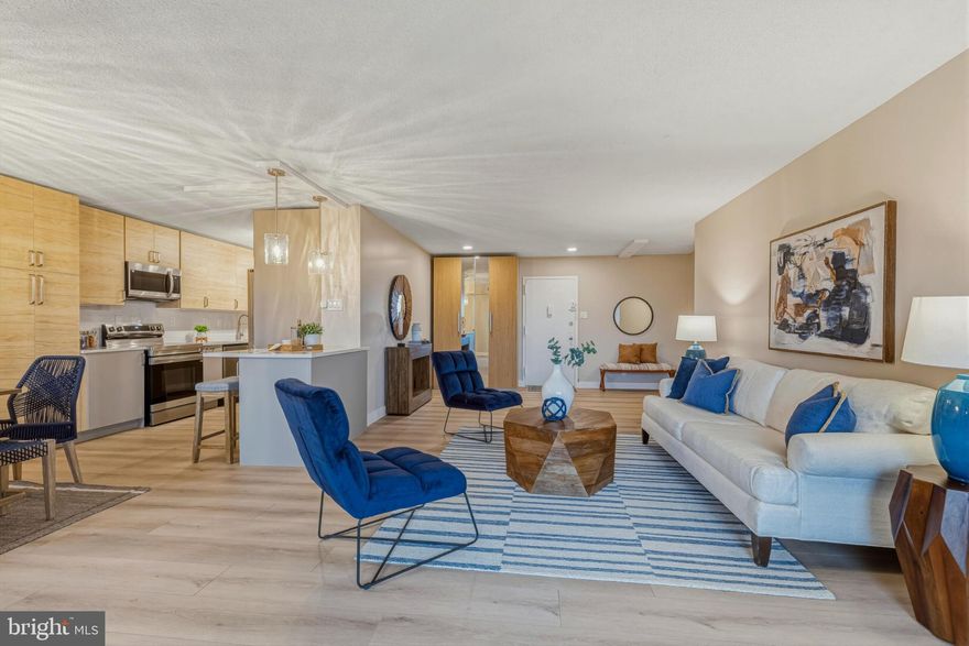 Welcome to 309 Yoakum Pkwy #1003 — a fully reimagined 10th-floor residence inside the gated Watergate at Landmark community. This home has been completely renovated with a clean, modern aesthetic and warm designer finishes throughout.

The brand-new kitchen features custom flat-panel cabinetry in a natural wood tone, quartz countertops with full-height backsplash, stainless steel appliances, sleek hardware, open shelving accents, and a built-in stacked front-load washer and dryer seamlessly integrated into the cabinetry. It is both beautiful and highly functional.

The bathrooms have been transformed into spa-inspired retreats with frameless glass shower enclosure, marble-look tile walls, mosaic shower flooring, recessed niche, quartz double vanity, and contemporary brushed nickel fixtures. Every detail feels intentional and elevated.

New flooring, fresh paint, updated lighting, and thoughtful finishes throughout make this home truly move-in ready.

Enjoy private balcony views from the 10th floor along with the unmatched amenities of Watergate at Landmark — indoor and outdoor pools, tennis courts, fitness center, sauna, walking paths, putting green, playground, and 24-hour gated security. Conveniently located near Van Dorn Metro, Old Town, Pentagon, National Airport, Amazon HQ2 and DC.

Turn-key. Modern. Effortlessly stylish.