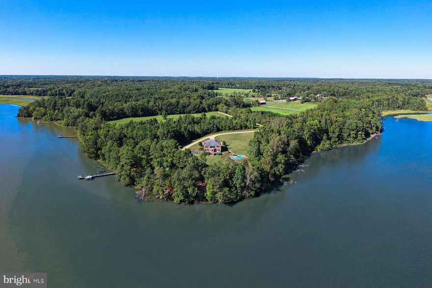 Welcome to The Retreat at Hattons Rest!

A truly exceptional private waterfront estate set on a secluded 5.26-acre peninsula with an impressive 1,100 feet of pristine shoreline along the historic St. Mary's River.

This magnificent 7,376-square-foot custom all-brick colonial home offers stunning water views from the kitchen and family room, where expansive windows perfectly capture the river's beauty and abundant wildlife, including soaring bald eagles, ospreys, great blue herons, wild turkeys, and roaming deer.
Launch your boat year-round from your private 100-foot pier and fish for rockfish, flounder, bluefish, perch, and crabs right from your backyard—or take a quick 20-minute cruise to the Potomac and Chesapeake Bay for trophy-sized Cobia, Drum, and citation rockfish.

Step inside to a grand foyer featuring a custom staircase that opens to sweeping rear river vistas. The main level offers a convenient bedroom and full bath, ideal for guests or multi-generational living. The primary suite and kitchen bask in morning sunlight, while the family room glows with sunsets. A covered second-floor porch and large rear masonry deck extend the outdoor living space, providing even more breathtaking views from the family room, kitchen, and select bedrooms.

Relax in the low-maintenance 20x30 Sylvan pool from spring through fall, then unwind by the wood-burning fireplace in the spacious family room or the gas fireplace in the primary bedroom when the weather turns cooler.

Additional features include cleared, level land perfect for horses or a small farm, remarkable privacy, and easy access to Patuxent River Naval Air Station (only 4 miles away), excellent public and private schools, St. Mary's College, shopping, dining, and nearby marinas.

More than just a residence, this property is a peaceful waterfront haven—an ideal family compound or enduring legacy retreat.