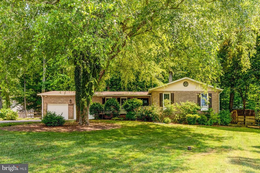 MAJOR price reduction!  Now priced at $415,000! This 3-bedroom ranch-style home boasts recent updates to the Kitchen and Bathrooms. Packed with hardwood floors throughout, a brick fireplace, an outdoor gathering area, and nearly an acre of land in a park-like setting! USDA Eligible! The home was previously appraised at $430,000.