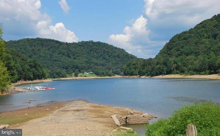 Lakefront lot on Yough Lake! Located right next door to Mill Run recreational area, offering public camping, restrooms, boat launch and beach area. Per the GC health department, the lot is not buildable due to excessive slope though you can enjoy many other activities within walking distance. HOA is non-operational, per owner.