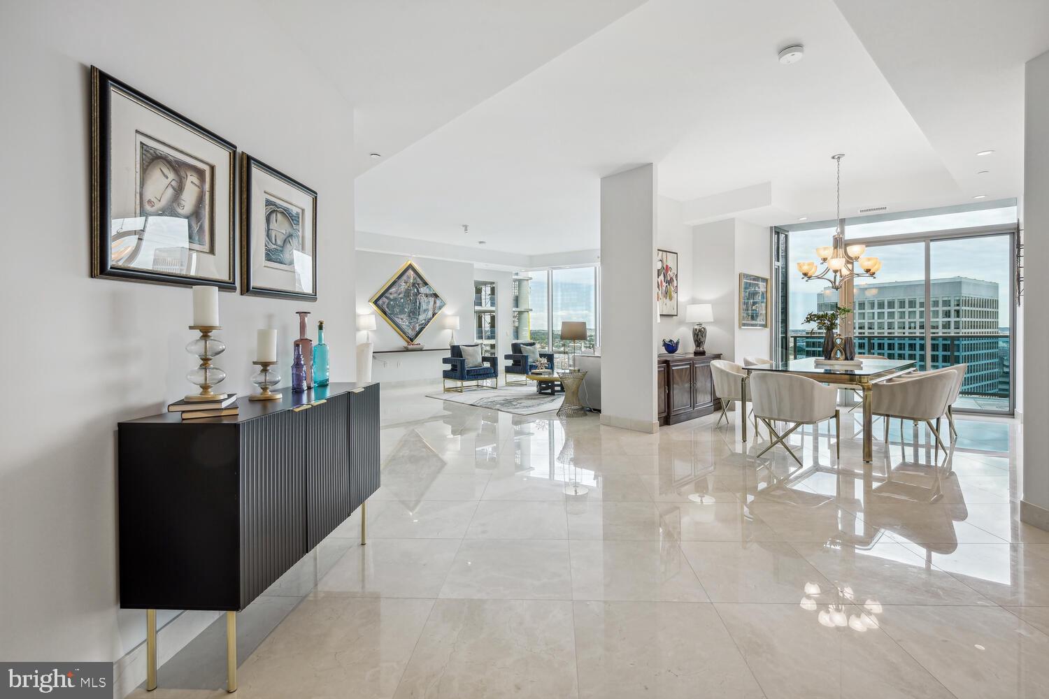 Nestled in the heart of Rosslyn, Turnberry Tower is a 26-story building that offers a lifestyle of unparalleled sophistication, combining breathtaking views, thoughtful design and unmatched amenities. This stunning 2-bedroom plus den, 3.5 bathroom corner unit faces northeast with views of Georgetown, the Potomac River and the Kennedy Center. As you exit the semi-private elevator and step into the foyer, a spacious 3,036 square foot open floor plan awaits. You'll find marble floors, 10+ foot ceilings, and abundant natural light through floor-to-ceiling windows, that encompass the entire unit. The gourmet kitchen includes Snaidero Italian cabinetry, equipped with state-of-the-art Miele and Sub-Zero appliances, with bar seating. The primary suite has dual walk-in closets, access to the balcony, spa-like marble bathroom with designer fixtures, soaking tub, glass enclosed shower, and dual vanities. The second bedroom suite provides tranquility and privacy - tucked away with a private hallway, walk in closet, and en-suite bathroom. The den, which could be converted back to a 3rd bedroom, has a full bath and is adjacent to the perfect home office space. The expansive private balcony, which can also be accessed via the living room, provides the perfect setting for relaxation and entertainment.
Enjoy a world-class range of amenities and white glove service, including: 24-hour concierge, security, complimentary valet parking for residents and guests, heated indoor pool, state-of-the-art fitness center and yoga studio, spa, private media/theater room, owner's lounge with full kitchen, business center, and outdoor terrace. This unit has TWO adjacent parking spaces, P4-48 & P4-49 situated right next to their 16 x 8 storage unit (BG4-10), which is conveniently located right in front of the doors to the elevator lobby. This property is in the heart of it all...0.2 miles to Rosslyn Metro, just a few blocks to Key Bridge/Georgetown, minutes to Reagan National Airport, downtown Washington, DC, and more!