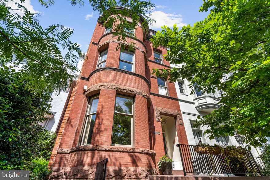 This impressive semi-detached brick row house is ideally located on a prominent street in Georgetown’s historic East Village. The Victorian-style residence has beautiful architectural details including exterior dentil trim, arched brick, and a sophisticated front turret. The house features a highly desirable floor plan with seamless transition between the gracious rooms. It is filled with an abundance of natural sunlight from large windows, which is further amplified by the high ceilings throughout. The elegant front vestibule leads to the welcoming entry foyer, which is complemented with black limestone floors. The living room, which can closed off with pocket doors, features lovely moldings, a beautiful bay window, and a fireplace with an intricate marble mantle. The neighboring dining room has an additional fireplace with marble detailing. Towards the rear of the home, the gourmet eat-in kitchen offers high-end stainless-steel appliances, a large center island with storage, a fireplace, built-in desk, and two exterior doors to the rear terrace and garden. The second level has two bedroom suites, including the luxurious primary. The primary bedroom is graced with a charming bay window and provides a walk-in closet, fireplace, and a separate private office/sitting room. The well-appointed primary bathroom offers dual vanities and a frameless glass shower. The second bedroom on this floor has an en-suite bathroom and overlooks the rear garden. The third floor has two additional bedrooms, both with fireplaces and large closets, and an attractive hall bathroom with a linen closet. The top floor acts as a flexible use loft space with abundant storage. The room can be used as fifth bedroom and has an en-suite marble bathroom with a frameless glass shower. The lower level of the residence has a separate entrance from the front and offers a large recreation room and abundant storage space. There is also a convenient in-law/staff suite with separate access, a kitchenette, and a full bathroom. The laundry room is also found on this floor and has a utility sink, folding station, cabinetry, and a secondary refrigerator and freezer.  There is off-street parking in the back for one car. This spectacular residence is within close walking distance to neighborhood favorite restaurants, shops, and parks.