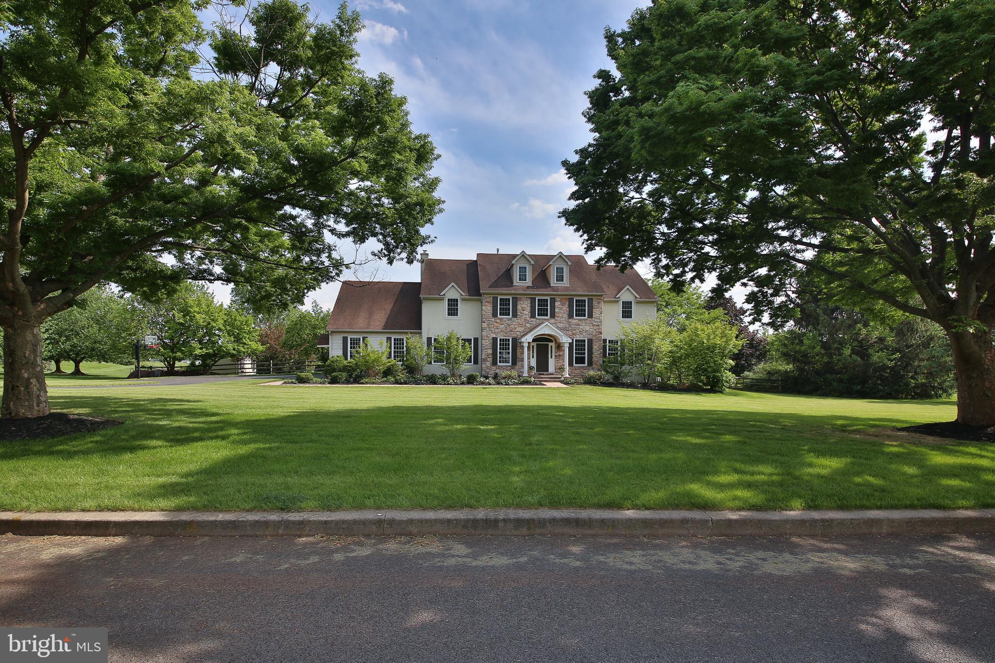 Welcome to this meticulously maintained 4-bedroom custom-built home in the prestigious Estates at Brookside. Thoughtfully designed with tasteful upgrades throughout, this home offers the perfect blend of luxury, comfort, and functionality. Step into the grand two-story foyer, where gleaming hardwood floors, elegant wainscoting, dentil crown molding, and oversized windows fill the space with natural light. Just off the foyer, you’ll find a private study/den with custom built-in cabinetry and desk—ideal for a home office or study. The formal living room flows into a sophisticated dining room offering beautiful views of the backyard and pool, with a show-stopping chandelier adding extra elegance. A stylish powder room features eye-catching printed tile floors. The heart of the home is the spacious family room with a cozy fireplace, built-in cabinetry, and sliding doors that lead to a Trex deck—perfect for entertaining. The chef’s kitchen impresses with top-of-the-line appliances: Sub-Zero refrigerator and freezer, Miele wine cooler, cooking range, double ovens and warming drawer. Kitchen also features under-cabinet lighting, custom soft-close cabinetry, granite countertops, a large island, walk-in pantry, and a charming breakfast nook with deck access. A standout feature of this home is the second study/home office with built in-shelving and private garage access, Rounding out this level is a laundry room with utility sink and storage closet, with garage access. Upstairs, the luxurious primary suite features a fireplace, wainscoting, a peaceful sitting area overlooking the backyard, attic access, and a beautifully designed en suite bath with shiplap walls, soaking tub, dual sinks, oversized shower, towel warmer, extractor fan which doubles as a heater, and a spacious walk-in closet. Another bedroom enjoys its own en-suite bath and walk-in closet, while two additional bedrooms share a Jack and Jill bathroom with dual sinks. Two linen closets provide added storage on this level. The finished basement offers recessed lighting, a tiled ceiling, and direct access to the pool deck. Enjoy movie nights in the separate theater room, with plenty of additional space in the storage rooms. Situated on 2.85 beautifully landscaped acres, the backyard is a true private retreat featuring an in-ground pool with a charming pavilion. Whether you’re relaxing by the pool or hosting summer gatherings, this outdoor space is sure to impress. Enjoy the tranquility of this exceptional neighborhood while being just a short drive to Doylestown Boro, shopping, dining, golf clubs, and parks. Don't miss out on the opportunity to call this home yours- book your showing today! (Professional Photo's of exterior and interior will be up on Wednesday)