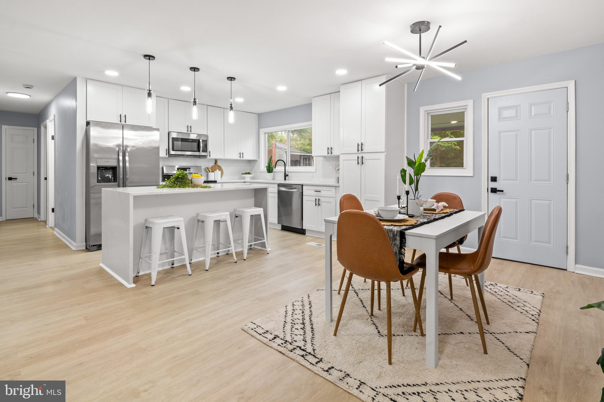 Welcome to your dream home in the sought-after Shoreland neighborhood of Glen Burnie, where spacious living meets modern style and convenience. This stunning 5-bedroom, 2.5-bathroom split foyer has been thoughtfully reimagined with high-end finishes, offering the perfect blend of elegance and functionality. From the moment you step inside, you’ll be greeted by a bright and airy main level that offers the perfect open-concept living room that flows seamlessly into the designer kitchen, the true heart of the home. You'll fall in love with the waterfall-edge quartz island, premium stainless steel appliances, custom cabinetry, and striking finishes that make this space ideal for both everyday living and sophisticated entertaining. Down the hall, you'll find three generous bedrooms, including a primary suite with its own private half-bath and a beautifully updated hallway bathroom with modern finishes. The fully finished lower level provides even more functional space with two additional bedrooms, a full bath, and a spacious family room—perfect for a home office, guests, or bonus entertainment zone. Outside, enjoy a large corner-lot yard with a patio that’s perfect for ideal for quiet mornings or summer evenings. A private driveway provides ample parking, and the location can’t be beat with just minutes to major commuter routes leading to Baltimore, Annapolis, Fort Meade, and DC. This is your perfect opportunity to own a move-in-ready home in a quiet, established neighborhood with plenty of space to grow. Schedule your showing today!