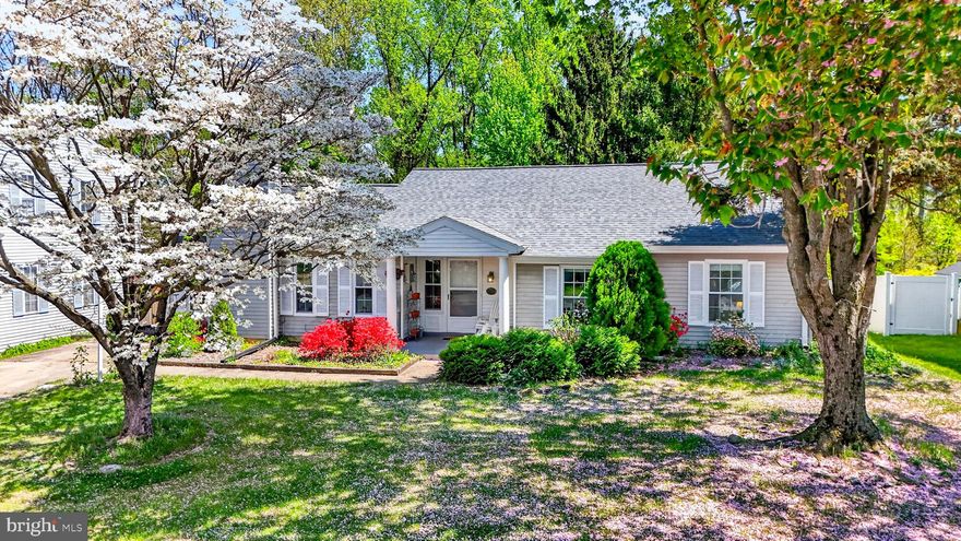 Looking for an affordable starter home? Or maybe you are ready to downsize without sacrificing outdoor space? This charming, cottage-style ranch fits the bill and is offered at an exceptional value! Step inside the welcoming foyer and immediately feel at home. The spacious family room features a full wall of windows, bringing the outdoors in, and beckons you to curl up with a good book. The eat-in kitchen offers abundant cabinetry, modern appliances, a pantry, and a dining area with sliding-door access to the rear deck. Just off the kitchen, the cozy living room invites you to relax by the wood-burning fireplace. The primary suite includes a large walk-in closet, an additional double closet, and a private ensuite bath. The two additional bedrooms, both with ceiling fans and ample closets, share the hall bath with its tub-shower combo. Enjoy peace of mind with numerous recent updates, including roof (2022), replacement windows (2022), dishwasher (2022), HVAC (2023), chimney crown (2023), gutters, soffit, and fascia (2023), deck (2025), and R-7 attic insulation (2023). Energy-efficient solar panels (2024) help keep utility costs low. Additional highlights include a two-car driveway and two attached walk-in sheds for ample storage. Unwind on the rear deck overlooking a peaceful yard with a woodland backdrop—perfect for morning coffee or evening relaxation. Conveniently located near shopping, dining, recreation, and commuter routes, this move-in ready home offers comfort, value, and easy one-level living.