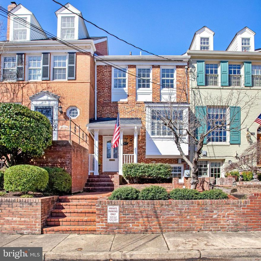 Gorgeous 3 bedroom, 2.5 bath townhome with dedicated parking!  Located on a quiet impasse at the southernmost point of S. Lee Street leading to Jones Point Park. This must-see Yates Gardens home offers the convenience of a walkable community and a private oasis which is a rare find in Old Town. The beautiful chef’s kitchen features abundant cabinet storage and counter space, stainless steel appliances, a conveniently located desk area, and the most comfortable window seat looking out over the wooded parkland.  The spacious and light-filled main level affords easy living with seamless flow between the kitchen, dining room, and living room. Enjoy the cozy wood-burning fireplace and expansive windows across the back of the home flooding it with natural light.  A half bath is located on the main floor of the home while the upper level is thoughtfully designed with 2 roomy bedrooms, a remodeled full bath, walk-in closet, laundry, and access to the attic for storage.  The lower level is a versatile space encompassing a family room with custom built-ins, wood-burning fireplace, and access to the private back patio.  The third bedroom or office has an en suite full bath and a separate entrance.  Don't miss this pristine home in move-in condition in a premier location just steps to the Mt. Vernon Trail, parks, the Old Town waterfront and close proximity to public transportation, Reagan National Airport and Washington, DC.