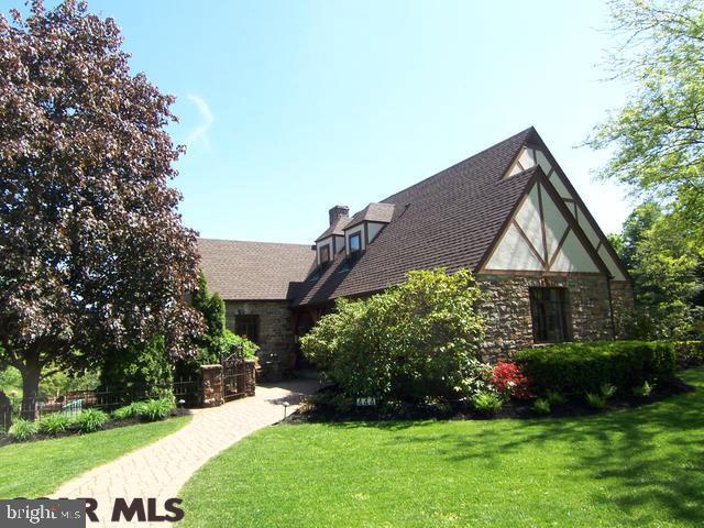 Divine & unforgettable historic Holmes-Foster Stone Tudor, rich in architectural detail & charm. Value a new tastefully appointed kitchen & 2 updated full baths. Impressive characteristics include hardwood & ceramic tile floors, arched entryways, built-in shelves & original cabinetry. The kitchen boasts an eat-in nook, granite & custom walnut cabinets. You'll adore the sunroom, providing cheery space & access to a deck for expanded summer entertaining. The living room is spacious w/cathedral ceiling, French doors, & a lovely fireplace. The main floor also features an office, full bath & bedroom. Awake to amazing views of Nittany & Tussey mountains from the master. Two additional bedrooms & a full bath complete the upper level. Secluded garden surrounded by wrought iron gate & fence provide a inviting private oasis. Ideal location-campus, school, pool nearby. Also notable: brick patio, oversized 1-car garage, workshop. Visit http://www.statecollegepa.us/DocumentCenter/Home/View/1116