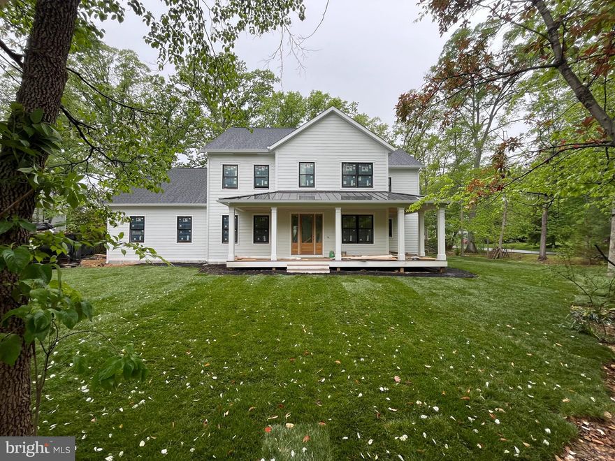 Stunning new craftsman style home in the heart of Fort Hunt's Waynewood school district. A striking exterior with black windows, white siding, and standing seam metal roof harken back to a bygone area. Sited impressively on a corner lot, this home says "home." Step inside and find anything but the ordinary. Large open layout allows for casual space for daily life while providing seamless flow for large-scale entertaining. Soaring ceilings, hardwood flooring and built-ins all combine to provide the character you want. Huge chef's kitchen is the heart of the home with 48" range, built in refrigerator and tons of custom cabinetry. Butler's and separate large pantry room ensure you have plenty of space to serve guests and hosts functions. The main level also has a large mudroom with built-ins, bedroom with ensuite bathroom (easily used as an office) and telescoping doors that allow the outdoors in on your glorious deck. Upstairs, there are 4 generous bedrooms with walk-in closets, hardwood floors, and 3 full bathrooms. A spacious laundry room also helps keep the clothes where they belong. The primary suite is well appointed with extensive moldings, gorgeous white oak flooring, and relaxing sitting room, two walk in closets and a lux marble bath with dual sinks and soaking tub. With so much space, it's easy to focus on preparing and unwinding from your day. The lower level has a large recreation room, work-out room, 6th bedroom, 5th full bathroom and tons of storage space. A second gas fireplace adds comfort and ambiance to this level.

Outside, you will find yourself within walking distance to Fort Hunt's local shopping. Drycleaning, grocery, pharmacy, a hardware store and a variety store are all just a block away. The GW Parkway with it's miles of bike trails and Potomac River views are just up the street. 

Welcome Home!