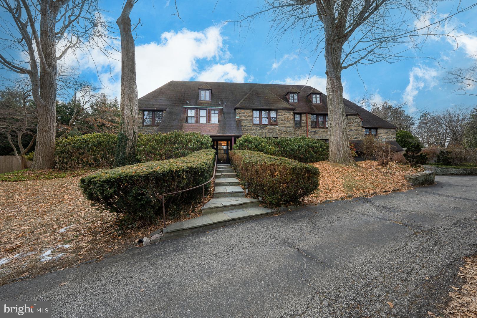 Welcome to 109 Ringwood Rd, a stunning home in Bryn Mawr on a quaint private street. This unique Norman-style all-stone home features six bedrooms, 5 full bathrooms plus two powder rooms. There is over 4500 square feet of living space on two floors, and another 685 square feet finished on the lower level.
Upon entering, the home's grandeur is evident in the wide transverse foyer with high ceilings accentuated by elegant crown moldings, a striking turned staircase, and a quaint powder room accentuate the home’s functional elegance. The sophisticated ambiance is further enhanced by the warm glow of wall sconces and classic chandeliers, and complemented by recessed lighting. Original and newer hardwood floors abound throughout the first floor, and relaxation awaits in the lovely, sunny fireside living room. The classic formal dining room features built-in corner cabinets, and chair rails and comfortably accommodates a large dinner party.
A Gardner/Fox redesign and build-out began with the butler's pantry/wet bar complete with a beverage center and second dishwasher and is adjoining the heart of the home, its kitchen. This culinary haven is equipped with a striking cobalt blue 48" Blue Star range & matching range hood featuring a double oven, gas cooktop, and adjacent polished black slate tops. The open kitchen design features a breakfast nook with built-in seating and a lovely center island finished in Quartzite with seating space suitable for five. An opened back stairway accesses the second-floor bedrooms and a full bathroom, while yet another open stairway leads downstairs to a smartly designed mudroom, laundry, and ample storage closets with a doorway leading to the attached two-car garage. French doors off the kitchen lead to the fenced backyard, and the walk-out daylight basement is finished and includes a convenient powder room, a large storage closet, and a large utility room.
The primary suite is highlighted by a lovely ensuite bathroom, featuring a custom double bowl vanity, a freestanding soaking tub, a luxurious marble shower, with a private toilet, and an enormous walk-in closet with custom shelving, ensuring a place for everything. Two additional large, ensuite bedrooms complete the second floor, with two additional bedrooms and one full bath on the third level.
The home offers year-round comfort with central AC, comfortable steam radiator heating, and radiant heating in some floors.
Experience the pinnacle of luxurious living at 109 Ringwood Rd, a perfect blend of old-world charm, elegance, and practical modern-day amenities.