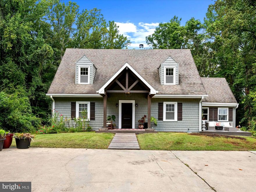 Renovated and well-maintained, almost 2,200 finished square feet and $300,000 worth of improvements in the last 10 years. Covered front porch.  Hardwood floors in the foyer, kitchen, dining room, and living room. In the living room, custom-built-ins, crown molding, and tile that surrounds the wood-burning fireplace. Additional space that can be used for a home office/playroom. Tons of natural light and its own private balcony that overlooks the backyard. The kitchen features a large center island, 42" cabinets, granite countertops, stainless steel appliances Dishwasher '20, Microwave '20, Refrigerator '14, Double oven '14, Induction stovetop '14, and soft-close hinges. There is another deck that is located off the rear of the kitchen.  On the second level, there are three bedrooms (one has a bonus room), two full baths, laundry area. The primary bedroom has a walk-in closet and updated full bath with dual sinks. Conveniently located upstairs are the front loading washer ('18) and new dryer ('21). The bedroom closets have custom wood-shelving units. This home was built in 1950, but has undergone TWO recent renovations (2014 & 2021) and is like-new! Improvements in the last 10 years include new:  New water filter & softener. Septic System. Electrical (200 amps) and lighting fixtures. Plumbing. Dual HVAC System. Hot Water Heater. Windows. Doors (interior & exterior). Attic insulation.  Drywall & paint.  Flooring (Hardwood, Tiling, Luxury Vinyl, and Carpet).  Wood Fireplace Insert. Unfinished Basement waterproofing system and sump pump.  Staircase replaced with railings/posts/balustrades.  Ply Gem Siding . Gutters.  Decks replaced.  New water filter & softener.  Stacked stone accent wall. Custom woodwork throughout the home. This home sits on over .50+ acre, is move-in ready, and just minutes from Annapolis.