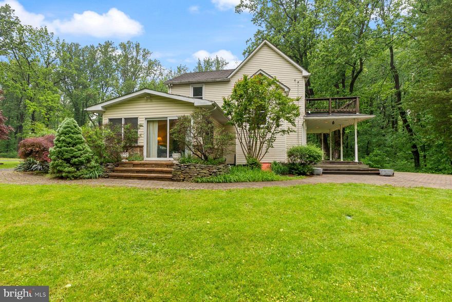 EXCEPTIONAL VALUE at a REDUCED PRICE! Rare opportunity to own a 5-acre property in Eastern Howard County, surrounded by protected parkland. Privacy, space, and potential in a highly desirable location — this one won't last! - You won't find another property like this in Howard County. Nestled on five private acres, this unique home is virtually surrounded by protected land—bordered on three sides by State Parks and Forest. A scenic trail winds down to the beautiful Patapsco River, offering direct access to nature right from your backyard. Despite the tranquil, secluded setting, you're just minutes from everyday conveniences: shopping centers, I-95, BWI Airport, Amtrak, and Rockburn Branch Park are all nearby.
The home itself is a blend of historic charm and modern updates. Originally built in the 1920s, the character-filled staircase to the second floor transports you back in time. Meanwhile, the kitchen, living room, and downstairs half bath have been tastefully updated for today’s lifestyle.
Step outside and unwind in your private hot tub—perfect for relaxing with a drink after a long day, or enjoying a cozy soak as snow begins to fall. The property also features several outbuildings, including two sheds with electricity—ideal for workshops, storage, or creative spaces. With no HOA and endless possibilities, this is a rare opportunity for those who want to live close to nature without sacrificing convenience.  If you're seeking a peaceful retreat with room to grow, explore, and dream—welcome home.