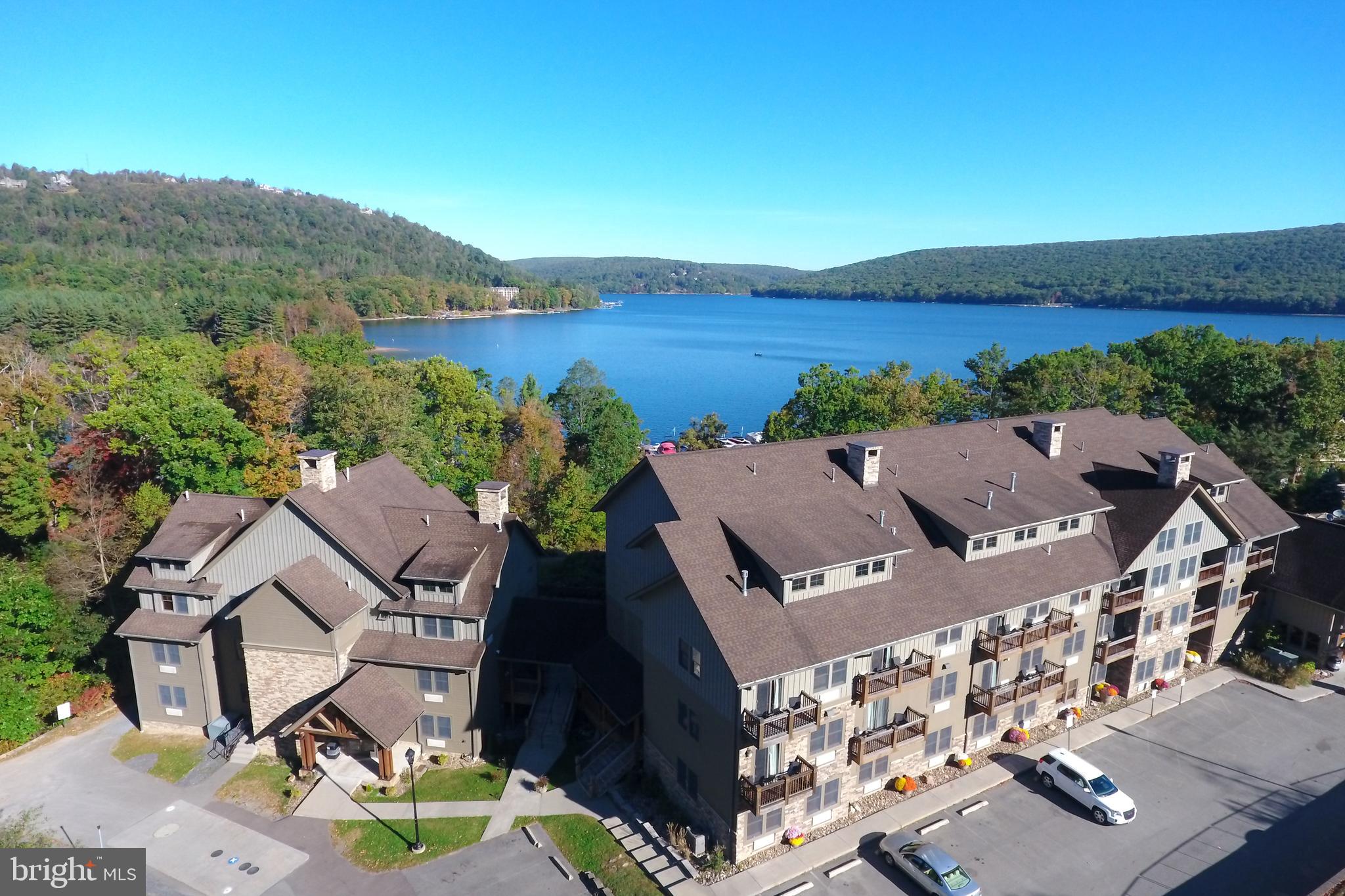 Ground-floor end unit with lake views at Silver Tree Suites. This one-bedroom layout packs in a gas fireplace, full bath with tub/shower, and a tidy kitchenette with microwave, dishwasher, and full fridge. Balcony doors open to Deep Creek air and filtered lake scenes. Community perks include sauna, gym, game room and more. Sold turn-key, fully furnished. Ductless units for heat and A/C. Monthly condo fee covers exterior, common grounds, and lakefront access. Don’t miss your chance to own premium lakefront without the price tag!