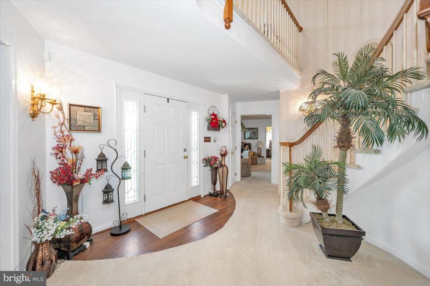 Elegant and  welcoming!  Come home to this spacious single-level living in this Ausherman-built brick rancher with bonus upper level!  Floor plan is perfect combination of open living with private areas too.  As you pull up to this beauty, you will be greeted by the rolling front yard and park next to the three-car garage.  The portico welcomes you to come into the spacious foyer with spiral staircase. To the right, you have a traditional feel of living room with adjoining dining room.  Heading straight back, you will see a grand kitchen with granite, center island with seating, and separate breakfast space.  To the left of the kitchen is a light-filled sunroom which provides exit to the deck overlooking the back yard.  Back inside, as you walk from the kitchen towards the front door, you will step down into a cozy family room with wood-burning fireplace.  The back of the family room opens to a small hall, home to the primary bedroom and bath,  and laundry.  From the entry immediately to the left is a pass-through library leading to the 2nd bedroom (now used as a home office).  A powder room is just to the right.  Climbing the spiral staircase, the upper level opens to a private study area overlooking the front yard.  Two additional bedrooms and a full hall bath complete the upper level.  The lower level of the home is used primarily for storage at this time, but some areas are partially finished.  There is a full rough in for a future bath and a walkout to the yard.