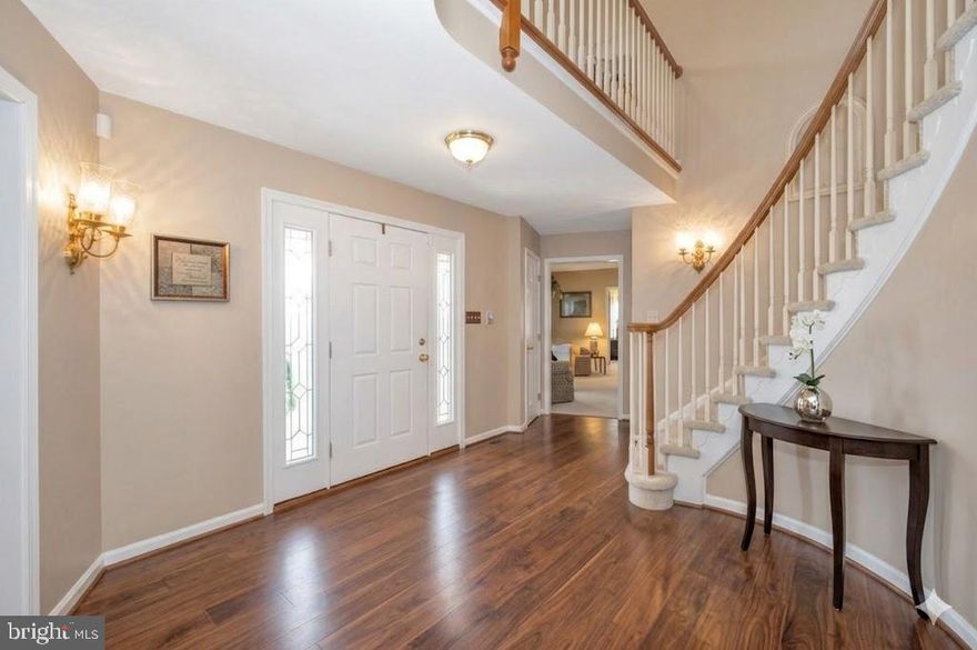 Elegant and  welcoming!  Come home to this spacious single-level living in this Ausherman-built brick rancher with bonus upper level!  Floor plan is perfect combination of open living with private areas too.  As you pull up to this beauty, you will be greeted by the rolling front yard and park next to the three-car garage.  The portico welcomes you to come into the spacious foyer with spiral staircase. To the right, you have a traditional feel of living room with adjoining dining room.  Heading straight back, you will see a grand kitchen with granite, center island with seating, and separate breakfast space.  To the left of the kitchen is a light-filled sunroom which provides exit to the deck overlooking the back yard.  Back inside, as you walk from the kitchen towards the front door, you will step down into a cozy family room with wood-burning fireplace.  The back of the family room opens to a small hall, home to the primary bedroom and bath,  and laundry.  From the entry immediately to the left is a pass-through library leading to the 2nd bedroom (now used as a home office).  A powder room is just to the right.  Climbing the spiral staircase, the upper level opens to a private study area overlooking the front yard.  Two additional bedrooms and a full hall bath complete the upper level.  The lower level of the home is used primarily for storage at this time, but some areas are partially finished.  There is a full rough in for a future bath and a walkout to the yard.