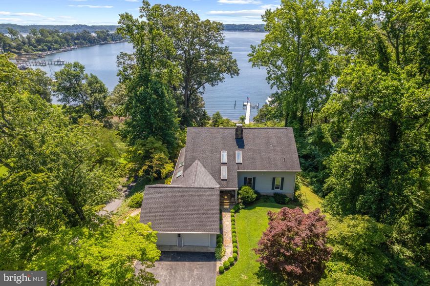 Charming Little Round Bay waterfront home in the Herald Harbor community with over 100 ft of private beach plus a deep water dock with 10 ft water depth.  This 4 bedroom, 4.5 bath home with 2 car garage and 3 finished levels has endless water views from almost every room.  The expansive view captures your attention upon entering the property and the screened porch adjoining the Living Room is sure to be where everyone will congregate to enjoy the view.  Open the sliding glass doors to experience the cool breezes; perfect for indoor/outdoor living. The entry level bedroom with ensuite bath provides a valuable opportunity for one level living and aging in place.  The 2 bedrooms with ensuites on the upper level are separated by a unique bridge creating a feeling of privacy, tranquility and stunning views with private balconies for each lucky occupant. A wonderful layout for family and friends!  The lower level feels like an additional main floor with high ceilings, tons of natural light, panoramic water views, bedroom, full bath, Family Room with fireplace and area for kitchenette.  Right outside the sliding doors is a spacious patio and path to the water's edge.  Deep water pier on Little Round Bay with boat lift, multiple slips and 10 ft MLW accommodates a variety of boats so you can enjoy the waterfront lifestyle however you choose! Quick access out to the Severn River to downtown Annapolis and beyond. An additional 0.542 acre adjacent parcel is available for purchase.  Welcome Home!