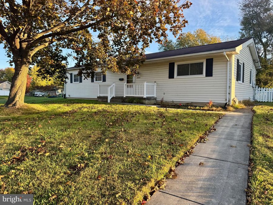 Beautifully maintained 2-bedroom, 1-bath rancher on a large corner lot with a fully fenced backyard! This charming home offers comfortable one-level living with an open layout, vaulted ceilings, and new luxury vinyl plank flooring. The updated kitchen features granite countertops, custom cabinetry, tile flooring, backsplash, and stainless steel appliances. Enjoy the bright dining area that opens to a cozy three-season room, perfect for relaxing or entertaining with direct access to the backyard. The spacious full bath includes a handicap-accessible jetted soaking tub and a separate stand-up shower. The full, unfinished basement provides plenty of additional space for storage. Additional highlights include an attached carport, extended driveway, and a convenient location close to shopping and major routes. Enjoy easy, single-level living with plenty of space inside and out!