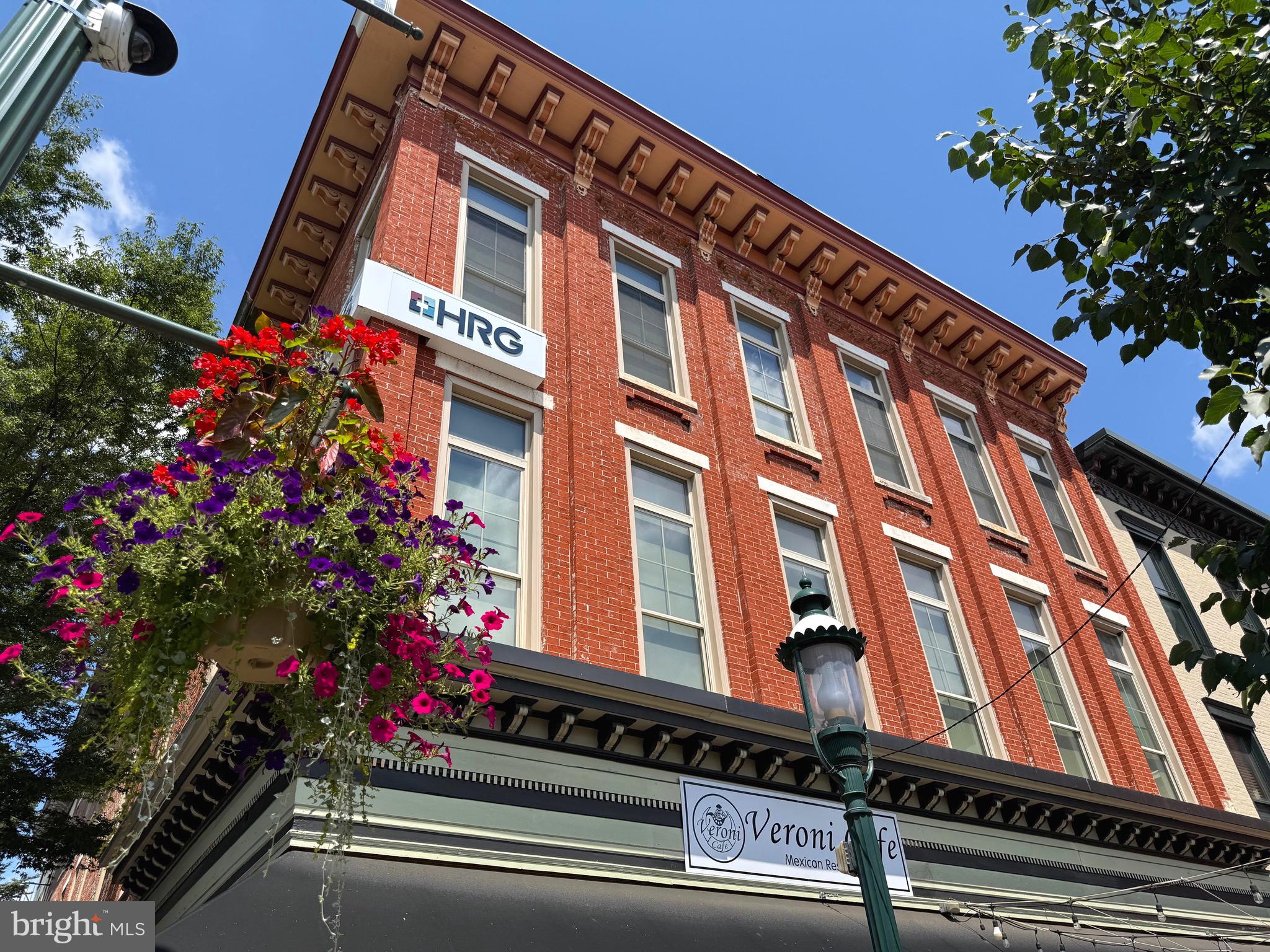 This is an extraordinary opportunity to own a beautifully restored historic building in the heart of Chambersburg’s vibrant downtown. This 8,500 sq ft mixed-use property boasts a prime location directly on the square, offering breathtaking views of the iconic Memorial Fountain and Franklin County Courthouse.
The first floor features a fully equipped restaurant space with indoor dining and a charming outdoor seating area—ideal for capitalizing on foot traffic and local events. The second and third floors offer premium office space, perfect for professional tenants or owner-occupants seeking top-tier amenities in a prestigious location. The restaurant and third floor suite are currently leased with great tenants. The second floor is vacant.
Originally built in the 19th century, the building underwent a full renovation down to the studs in 2017-2018, blending historic charm with modern efficiency. Just some of the updates include new mechanicals, windows, finishes, and the installation of a private elevator servicing the upper floors. There is a lobby with receptionist desk on the first floor that takes tenants up to the second and third floors. Each of the three floors have two ADA bathrooms. There are over 10 private offices on the second and third floors and lots of open space for cubicles and shared office spaces. There are large windows throughout that fill the space with natural light and provide breathtaking views of downtown Chambersburg.
This is a truly rare property to hit the market with great zoning. This is ideal for investors, business owners, or entrepreneurs looking to establish a flagship presence in Downtown Chambersburg.
Don’t miss your chance to own a centerpiece of Chambersburg’s historic square!
Contact me today for more information or to schedule a private tour.