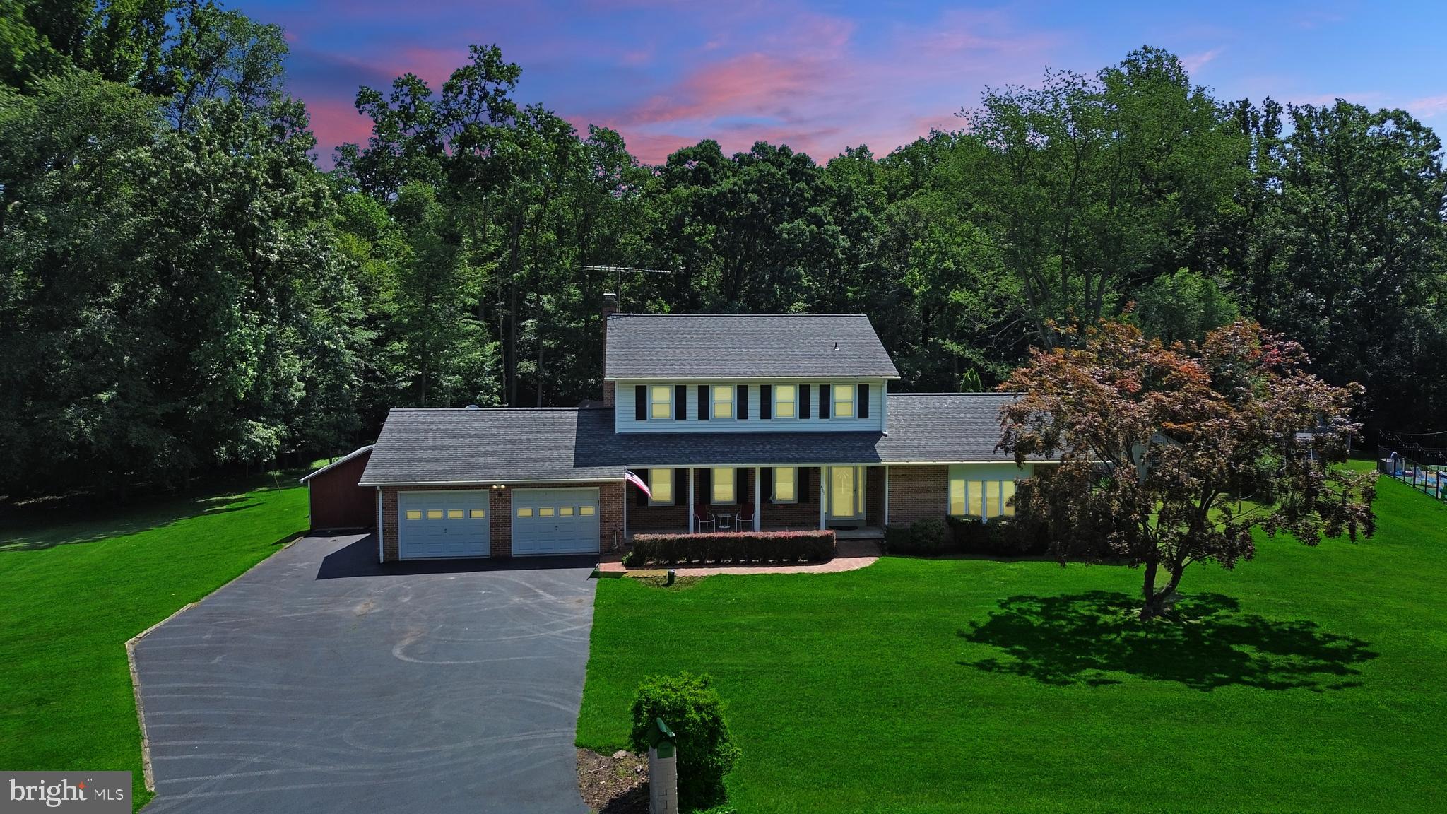 Wow! This charming home, located in a quiet and desirable neighborhood, truly has it all. Enjoy your mornings with a cup of coffee on the welcoming front porch, or unwind in the evenings on the expansive patio overlooking the fenced-in pool, flat backyard, and peaceful woods—perfect for play, relaxation, or entertaining. Four outdoor sheds provide ample storage and workspace. Inside, the light-filled eat-in kitchen offers generous counter space and Corian countertops, while the adjacent dining room flows into a formal living room located across from a versatile office or additional bedroom. Just off the kitchen, the cozy family room features a fireplace and built-in shelving. A convenient laundry room and half bath complete the main level. Upstairs, you’ll find four spacious bedrooms, including an updated hall bathroom with dual vanities and a luxurious primary suite boasting two walk-in closets and an upgraded full bath. The fully finished basement is ideal for entertaining with a wet bar, beautiful stone fireplace, full bathroom, and a massive rec room, plus an unfinished area for storage and walk-up access to the backyard. Additional highlights include gleaming hardwood floors, brand-new carpet, an oversized driveway, and a large two-car garage. Located just minutes from grocery stores, restaurants, and the shops of Downtown Frederick, this home offers everyday convenience in a peaceful setting. Don’t miss your chance—this one won’t last long!