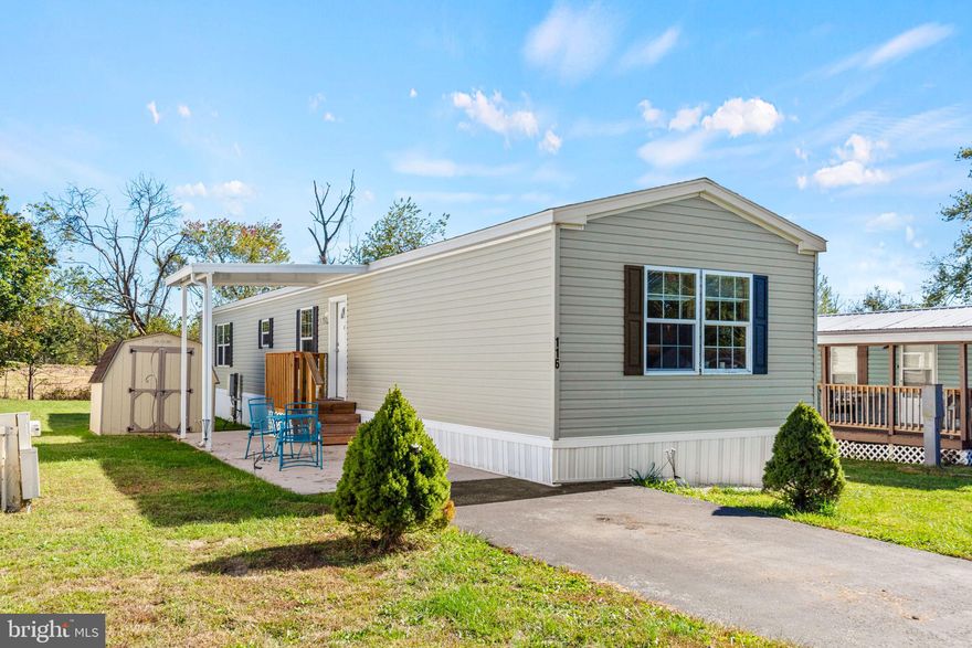 New Year. New Home. New Chapter. Get ready to fall in love with 116 Brownstone Park in Hummelstown, a beautifully maintained 2014 Redman model that proves comfort, style, and thoughtful design can truly come together. From the moment you arrive, it’s clear this home has been meticulously cared for—inside and out.
Outside, you’ll appreciate the oversized driveway with ample parking, covered front and rear patios ideal for morning coffee or evening unwinding, and a private storage shed for tools, hobbies, or weekend projects. Conveniently positioned near the park entrance and mailboxes, the location adds both ease and everyday practicality. Step inside to a calm, neutral interior that instantly feels like home. The inviting living room flows seamlessly into the open kitchen and dining area, creating a warm and functional space perfect for both daily living and entertaining. Just off the dining area, a dedicated mudroom with washer and dryer hookups and a secondary entrance adds convenience—especially after outdoor activities or yardwork.  The primary suite is a true retreat, featuring an ensuite bath with soaking tub, separate shower, and two closets, including a spacious walk-in. On the opposite side of the home, a generous secondary bedroom with a walk-in closet and an additional full bathroom provides flexibility for guests, a home office, or a quiet study. Every detail of this home reflects pride of ownership, from its thoughtful layout to its well-maintained condition. If you’re starting the year with new goals, this home is the perfect place to begin your next chapter. Located in the heart of Hummelstown, you’ll enjoy the charm of small-town living with unbeatable convenience—just minutes from Hersheypark, the Giant Center, Hershey Gardens, dining, shopping, and major commuter routes. It’s a lifestyle that balances comfort, accessibility, and opportunity. New year. New home. Make 116 Brownstone Park yours.