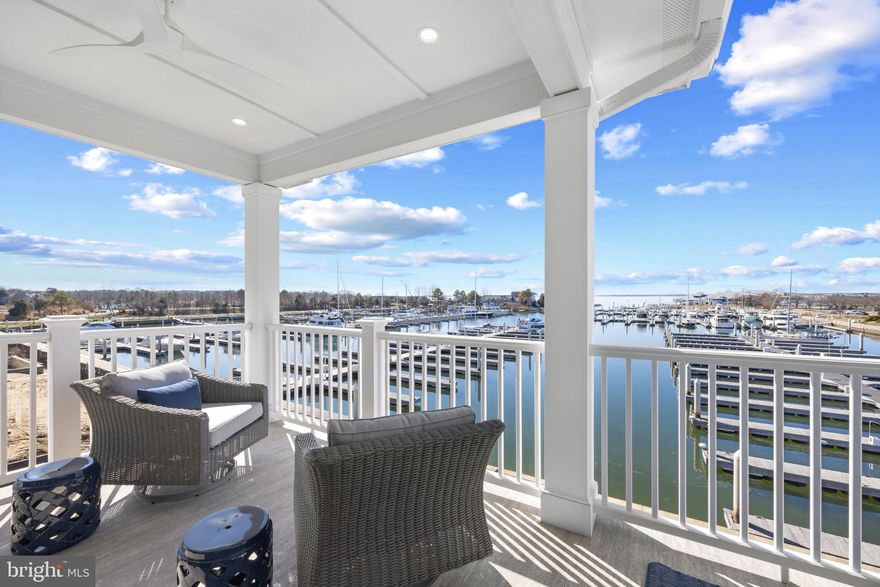 Welcome to Sunset Wharf, a refined waterfront enclave set within the picturesque Bay Bridge Marina, where coastal living is defined by sweeping views and effortless sophistication. This fully completed residence is one of just a select offering within the initial collection of three buildings, each thoughtfully designed with only two residences each, creating an intimate and private setting along the water’s edge.

Inside, the home unfolds across three levels with a thoughtfully designed four bedroom, four bath layout that offers both flexibility and comfort. A private bedroom and full bath on the entry level provide the perfect space for guests or a quiet home office. The main living level is designed for seamless everyday living and entertaining, highlighted by a warm and inviting living room with a gas fireplace that adds both comfort and ambiance. The upper level features two additional bedroom suites, including a serene primary retreat complete with its own gas fireplace. An elegant touch that enhances the sense of relaxation and retreat.

Expansive windows frame captivating views over the marina and out to the Chesapeake Bay, filling the home with natural light and creating an ever-changing backdrop of boating activity and open water. As the day winds down, the setting truly comes to life with breathtaking sunsets that paint the sky and reflect across the water. An experience to be enjoyed from both the interior living spaces and outdoor areas.

High-end finishes and a modern, open-concept design elevate the interiors, while the beautifully appointed gourmet kitchen and well designed baths enhance both form and function. Every detail has been curated to deliver a low-maintenance, lock-and-go lifestyle without compromising on luxury.

Ideally positioned within walking distance to waterfront dining, including Libbey’s Coastal Kitchen & Cocktails and Knoxie’s Table, residents also enjoy immediate access to marina amenities, scenic walking paths, and the relaxed rhythm of life on the Bay. Sunset Wharf offers a rare opportunity to own a newly completed residence in a thoughtfully designed waterfront community where every day feels like a getaway. Welcome Home!