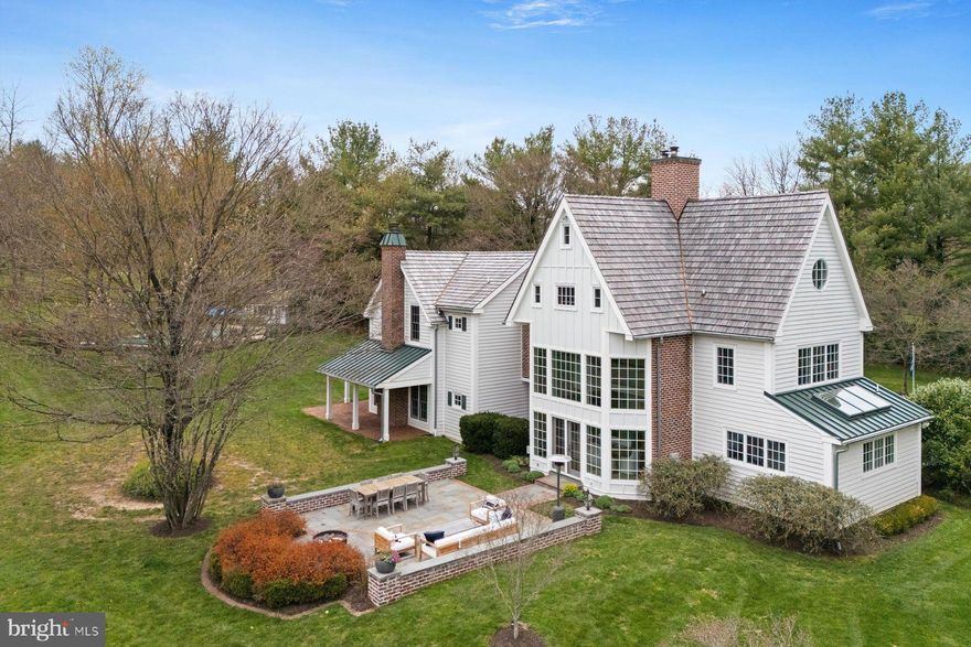 Modern Farmhouse with true southern exposure on nearly 3 private acres of idyllic grounds in premium Whitemarsh Township’s hunt country. This 5 bedroom, 4 full and 2 half bath, Asher Architect showstopper is the ultimate country retreat offering the best of both worlds - surrounded by 70+ acres of permanently preserved open space trails yet walkable to the bustling restaurants, theatres and shops of downtown Ambler. Newer seamless remodel and renovations make this a true turnkey property (cedar wood roofing, hardie plank siding, windows, kitchen, bathrooms, mudroom and flag stone patios, etc.).

The first floor is luxurious and comfortable featuring newer kitchen with all the bells & whistles, breath taking dining room with dramatic ceiling height and fireplace – both featuring step out access to spacious flagstone terraces perfect for al fresco dining. The expansive great room is an entertainers dream with numerous sets of french doors to covered patios, reclaimed barn wood flooring, wood burning fireplace and handsome built-ins throughout. Den, large mudroom, foyer and powder room complete the main floor. Second floor includes spectacular modern primary suite wing including newly remodeled bathroom, spacious walk-in closet and fabulous views of the picturesque grounds, balcony walkway to two additional bedrooms, jack & jill bathroom and laundry room. Third floor includes two bedrooms, newly renovated bathroom and ample closet space. Other features include, finished basement with fitness room & bathroom, detached garage with fully modernized 800 sq ft+ space above including kitchenette and full bathroom (bonus space could be used as office, nanny or in-law suite, etc.), perfectly situated in-ground pool with pool house and professional gardens. The location and property are unparalleled. A rare opportunity to secure a private turnkey country estate in an A+ location. Walking distance to Germantown Academy, connecting open space trails, minutes to major arteries, train stations and downtown Ambler.