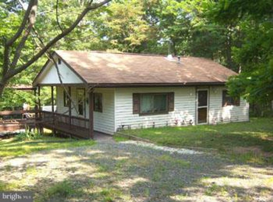 Country Cottage, setting on 5.44 acres of semi cleared land with natural spring and stream. 2 BR (1BR Septic), 1 BA, with an open design and cathedral ceiling that will welcome you home. New windows, Carpet, many recent improvements. 12 x 24 Garage,10 x 12 out building, Near the Cacapon and Potomac Rivers and Sidling Mt WMA for the outdoor enthusiast. Call Today!