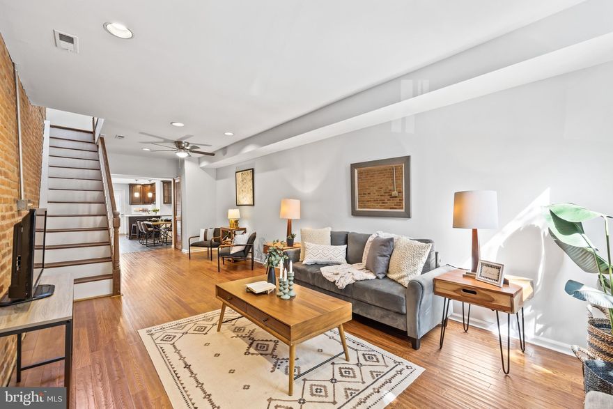 Welcome to 1418 Hull Street, a stunning 2-bedroom, 2.5-bathroom residence nestled in the heart of Locust Point. This thoughtfully designed home offers a harmonious blend of modern comfort and classic Baltimore charm. As you step inside, the first floor welcomes you with an abundance of natural light, accentuated by the character-rich exposed brick walls and gleaming hardwood floors. The spacious living room transitions into a gourmet eat-in kitchen. The kitchen boasts custom cabinets, sleek stainless steel appliances, and an inviting breakfast bar, making it an entertainer’s dream. On the second floor, you'll discover a generously sized front bedroom featuring a spacious closet, a recently renovated bathroom with a luxurious custom shower. The level is completed with a rear bedroom suite with an attached bathroom. The finished basement is an inviting additional living space. Here, you'll find a built-in electric fireplace that adds warmth and ambiance, along with a well-appointed bar for entertaining. The basement is completed by a storage/workshop area. Outside, a spacious rear patio awaits, providing the perfect setting for outdoor gatherings, and barbecues. Located just blocks away from Latrobe Park and Fort McHenry. You’ll also find yourself within walking distance of an array of neighborhood restaurants and bars, adding to the vibrant atmosphere of Locust Point. With its impeccable blend of style, comfort, and location, 1418 Hull Street is ready for it’s next owners this fall season!