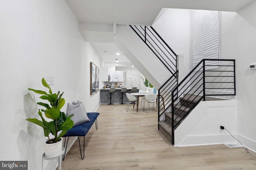 Recently Renovated 5-Bedroom, 2.5-Bath Modern Home – Move-In Ready! Property may qualify for grants and closing cost assistance up to $10,000+ for eligible buyers! Spacious 3-story home features luxury vinyl plank flooring throughout, recessed lighting, and a beautifully updated kitchen with granite countertops, stainless steel appliances, and modern cabinetry. The main floor includes a convenient half bath. Upstairs offers 3 nicely sized bedrooms and a full bath, while the third floor adds 2 additional large bedrooms—perfect for extra living space or a home office. A full unfinished basement provides endless potential. Conveniently located near public transportation, the 63rd Street El, and Philadelphia International Airport. Includes a 1-year home warranty. Schedule your tour today. Photos were taken when staged. Owner is a licensed real estate agent.