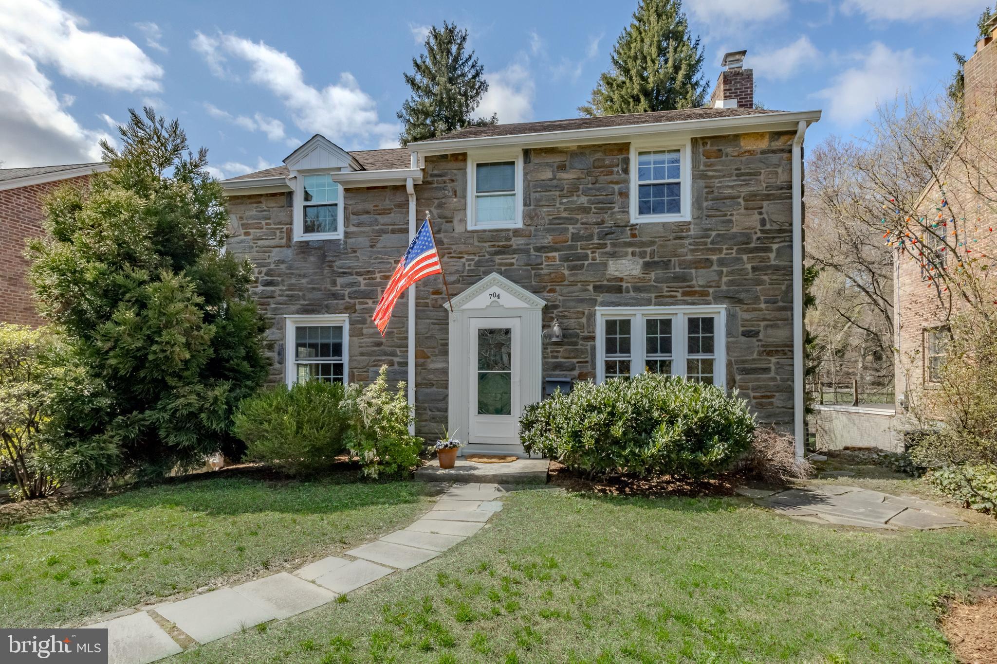 The very best of everything! Welcome to 704 Powder Mill Ln, Wynnewood. This classic stone front center hall Colonial home is steps from Powder Mill Valley park and playground and the beautiful Karakung Drive. Located in Haverford Township, just on the Lower Merion border you’ll be able to take advantage of all things Wynnewood, Ardmore and Havertown! The current owners have done an exceptional job renovating this home, creating a modern aesthetic throughout, but incorporating the original charm of the home. Pull up and fall in love with the stone front, beautiful original solid wood front door and landscaping. The first floor offers great space. The center hall entry welcomes you. The large living room can accommodate large furniture, has a beautiful fireplace with dental molding and bluestone hearth, recessed lighting, tons of natural light coming in from the larger windows and front bay and beautiful white oak flooring. The open concept of the dining room and kitchen is such a great space for everyday life and entertaining guests. The kitchen has been thoughtfully renovated very recently and couldn’t be more classic! White shaker cabinets, white subway tile, quartz countertops, a large farmhouse sink, great lighting choices, a nice peninsula with seating in a beautiful gray tone and room in the dining area for a larger table and service piece. The white oak floors span throughout this space as well and into the office/sitting room. Enjoy your morning coffee on the built-in bench seat or pull up a desk and create the perfect office or playroom! Beyond the sitting room you’ll find the perfect Den, with a door leading out to the newly renovated trex deck, overlooking the park-like backyard. Upstairs you will find 3 nicely sized bedrooms to include a primary with a newer full bath- it’s amazing! The industrial style sink, hexagon tiled floor, subway tiled shower and frameless shower surround make this bath a one of a kind. The hall bath is nicely sized, has a tub and neutral tilework. The 2nd floor has the original oak hardwood floors in excellent condition. The walk-out lower level of the home offers a great flex space! Throughout the years it’s been used as an office, play space, mudroom entry and an amazing storage room, etc. The laundry and utilities are in their own rooms for convenience and there is so much closet space down there as well. Enjoy the convenience of parking in your driveway and heading right in with a place to hang up coats, drop your bags and your shoes. This property offers plenty of driveway parking, an attached garage with street parking as well. The backyard of this home is absolutely beautiful and you will feel like you’re on a retreat each day with your view and large green space. The current owners of this home have taken so much pride in the craftsmanship of work done. Modernized but still classic- the best of everything! Enjoy the phenomenal location this home has to offer, all year round. Walk-to parks, playgrounds, dining and public transportation in minutes. This light and bright home is calling your name- answer it.