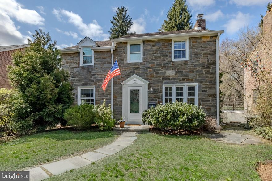 The very best of everything!  Welcome to 704 Powder Mill Ln, Wynnewood.  This classic stone front center hall Colonial home is steps from Powder Mill Valley park and playground and the beautiful Karakung Drive.  Located in Haverford Township, just on the Lower Merion border you’ll be able to take advantage of all things Wynnewood, Ardmore and Havertown!   The current owners have done an exceptional job renovating this home, creating a modern aesthetic throughout, but incorporating the original charm of the home.  Pull up and fall in love with the stone front, beautiful original solid wood front door and landscaping.  The first floor offers great space.  The center hall entry welcomes you.  The large living room can accommodate large furniture, has a beautiful fireplace with dental molding and bluestone hearth, recessed lighting, tons of natural light coming in from the larger windows and front bay and beautiful white oak flooring.  The open concept of the dining room and kitchen is such a great space for everyday life and entertaining guests.  The kitchen has been thoughtfully renovated very recently and couldn’t be more classic!  White shaker cabinets, white subway tile, quartz countertops, a large farmhouse sink, great lighting choices, a nice peninsula with seating in a beautiful gray tone and room in the dining area for a larger table and service piece.  The white oak floors span throughout this space as well and into the office/sitting room.  Enjoy your morning coffee on the built-in bench seat or pull up a desk and create the perfect office or playroom!  Beyond the sitting room you’ll find the perfect Den, with a door leading out to the newly renovated trex deck, overlooking the park-like backyard.  Upstairs you will find 3 nicely sized bedrooms to include a primary with a newer full bath- it’s amazing!  The industrial style sink, hexagon tiled floor, subway tiled shower and frameless shower surround make this bath a one of a kind.  The hall bath is nicely sized, has a tub and neutral tilework.  The 2nd floor has the original oak hardwood floors in excellent condition.  The walk-out lower level of the home offers a great flex space!  Throughout the years it’s been used as an office, play space, mudroom entry and an amazing storage room, etc.  The laundry and utilities are in their own rooms for convenience and there is so much closet space down there as well.  Enjoy the convenience of parking in your driveway and heading right in with a place to hang up coats, drop your bags and your shoes.  This property offers plenty of driveway parking, an attached garage with street parking as well.  The backyard of this home is absolutely beautiful and you will feel like you’re on a retreat each day with your view and large green space.  The current owners of this home have taken so much pride in the craftsmanship of work done.  Modernized but still classic- the best of everything!  Enjoy the phenomenal location this home has to offer, all year round.  Walk-to parks, playgrounds, dining and public transportation in minutes.  This light and bright home is calling your name- answer it.