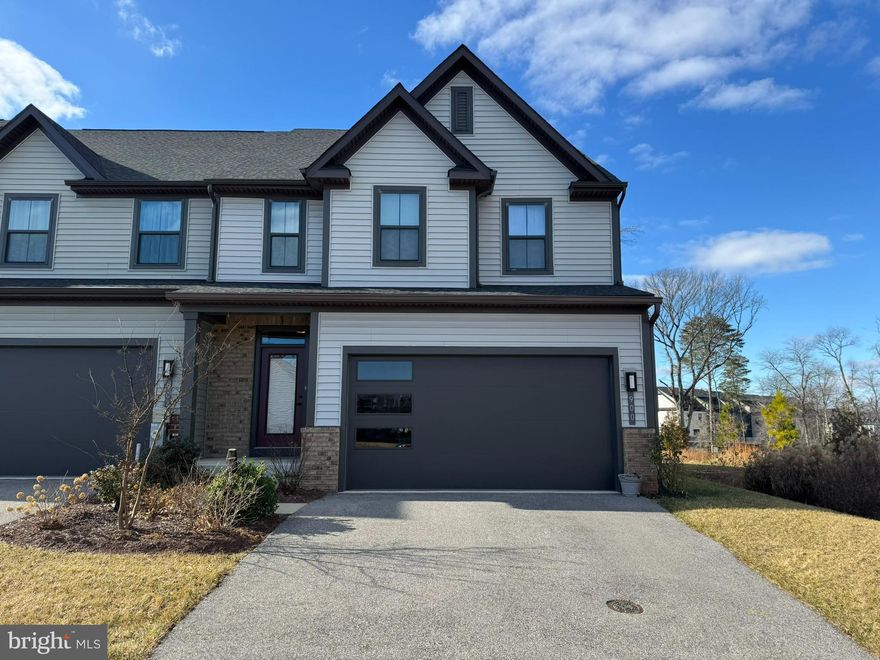 Terrific two-car garage villa in 55+ Tanyard Shores active community. Main level primary bedroom suite and laundry on main mean one level living. The upper level has two bedrooms and office space, plus a full bath. The lower level has a spacious efficiency apartment with kitchenette and full bath as well as a large storage/utility room. Enjoy outdoor living on your private deck that backs to a wooded area. Age in place with the Harbor House Community Center immediately next door to you. Enjoy the fitness center, yoga room, social club, outdoor community seating/grilling areas, outdoor fitness circuit, community garden, and much more.