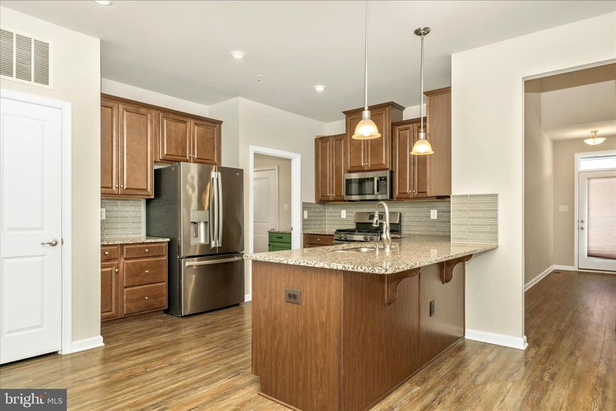 Terrific two-car garage villa in 55+ Tanyard Shores active community. Main level primary bedroom suite and laundry on main mean one level living. The upper level has two bedrooms and office space, plus a full bath. The lower level has a spacious efficiency apartment with kitchenette and full bath as well as a large storage/utility room. Enjoy outdoor living on your private deck that backs to a wooded area. Age in place with the Harbor House Community Center immediately next door to you. Enjoy the fitness center, yoga room, social club, outdoor community seating/grilling areas, outdoor fitness circuit, community garden, and much more.