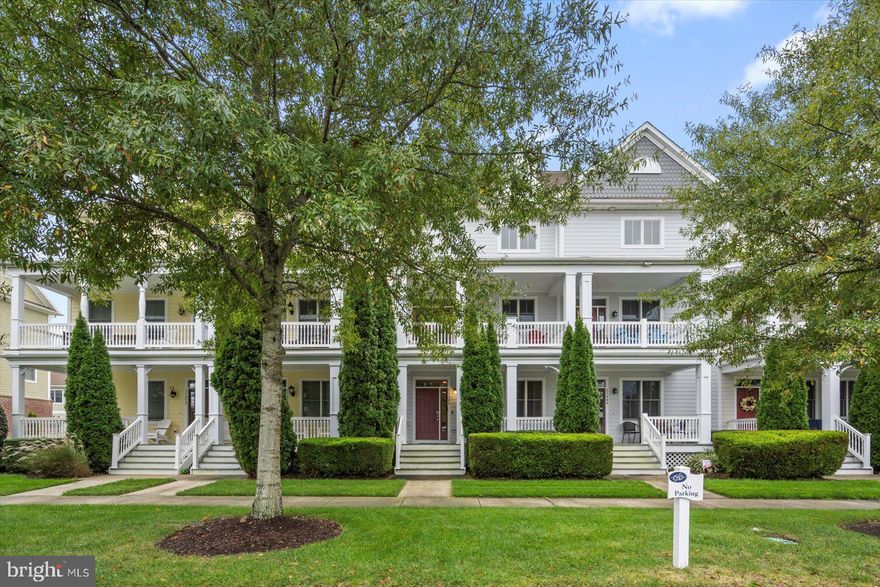 Arriving at 11446 W. Sand Cove Road, you will find a lovely furnished, 4 BD, 3.5 BA townhome with great views of a pond with a soothing fountain! This well-maintained home at over 2,000 sq. ft is spread out over 3 levels. It has inviting curb appeal with nice landscaping, and a charming covered front porch which looks across to a sprawling park. Enter the tiled foyer and see the attractive contrast of the white wainscotting against the dark wood stairs. This pleasing design element goes up both staircases and is in the dining area of the large eat-in kitchen. The kitchen features stainless steel appliances, gorgeous cherry cabinets and a breakfast area. From here, head outside to a covered balcony and like the porch below, it faces the park. Both are perfect spots to relax with morning coffee, read, perhaps catch the sounds of some Freeman concerts. 
Opposite the kitchen, the next spacious common area is the beautiful living & dining area with its luxury vinyl plank flooring. The focal point is the elegant gas fireplace with mantel & tile surround, flanked by two sliding glass doors that let in lots of daylight. Take one of them out onto a long balcony and you are treated to the 1st views of the pond & fantastic fountain! Now to the bedrooms where you’ll find the placement of them in this model is well done. For those that need an entry level bedroom, you can check that box and it is quiet and private too. This is because the 1st floor only has this one bedroom, a full bathroom next to it, a hall closet & a door to the 2-car garage. To the 3rd floor, the primary bedroom is on the right by itself. It has a walk-in closet and an ensuite bathroom with dual vanity and large shower. The left side has a full bathroom and 2 bedrooms. One has a walk-in closet, and both get a nice bonus: doors out to a balcony with more of the serene pond & fountain views! That makes 4 outdoor spaces and is a true standout for this property! The powder room & laundry room are on the 2nd floor, and the water heater was replaced in 2025. You are invited to explore this property and to see the views in person. Come see how this coastal townhome will fit your wants and needs. Making Bayside impossible to beat as a premier, sought-after community is when you add to the extensive list of amenities these 2 unique offerings: (1) the Bayside Institute with a wide variety of educational classes & activities. (2) Freeman Arts Pavilion with arts & music from a variety of performers including national, chart-topping, award-winning artists right in your backyard! Amenities include on-site security, outdoor pools, indoor pool, sauna, jacuzzis, tennis, pickle ball, a dog park, basketball, bocce, fitness center, the Jack Nicklaus Signature Golf Course, Signatures bar & grille, kayaks and more! The beauty of this community and its many amenities to be enjoyed either on your own or as part of a Bayside planned activity make it hard to leave here. Though when you do, the beaches, area attractions and more are just minutes away. Remember, Life is Not a Dress Rehearsal, Own at The Beach!