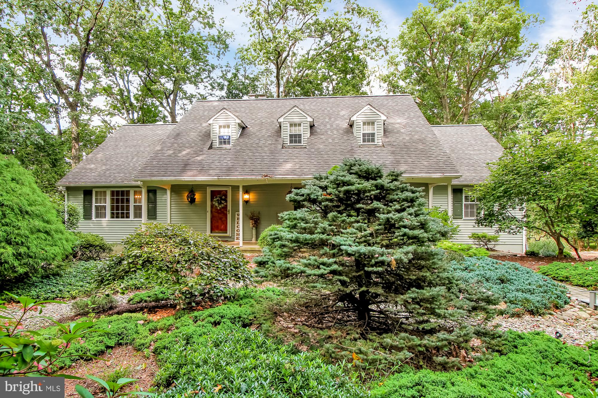 Looking for peace and quiet? You just found it!   At the end of your private driveway awaits this beautiful Cape Cod style home on 4.8 acres.  You are surrounded by tress, mature landscaping and the home backs to Manor Golf Course.  Enjoy the view from your covered front porch or entertain your guests on the rear deck which also has a screened in porch area. Random width hardwood floors greets you at the center hall entry with crown molding and chair rail and leads to the spacious family room with wood cathedral ceiling and full wall stone surround fireplace and a wall of windows overlooking the golf course.  Formal living room with hardwood floors, crown molding and chair rail adds additional entertaining space.  Step into your custom eat-in cherry kitchen with granite countertops, tile back splash and all appliances remain.  Off the kitchen sits your sunroom with hardwood cathedral ceiling and a wall of windows sure to please.  The dining room comes with crown molding, chair rail and hardwood floors.  At the other end of this almost 3500 square foot home is the owner's suite which features hardwood floors, a sitting room/office, a walk in closet and a large master bath with tiled walk-in shower with glass surround and corner soaking tub.  The main level also features a powder room and laundry mudroom.  Upstairs you will find two additional spacious bedrooms with hardwood and the recently remodeled hall bath.  There is also access to an oversized walk-in attic space that could be finished as a fourth bedroom.  Features include a hi efficiency geothermal HVAC and an oversized rear entry 2-car garage.  This one won't last!