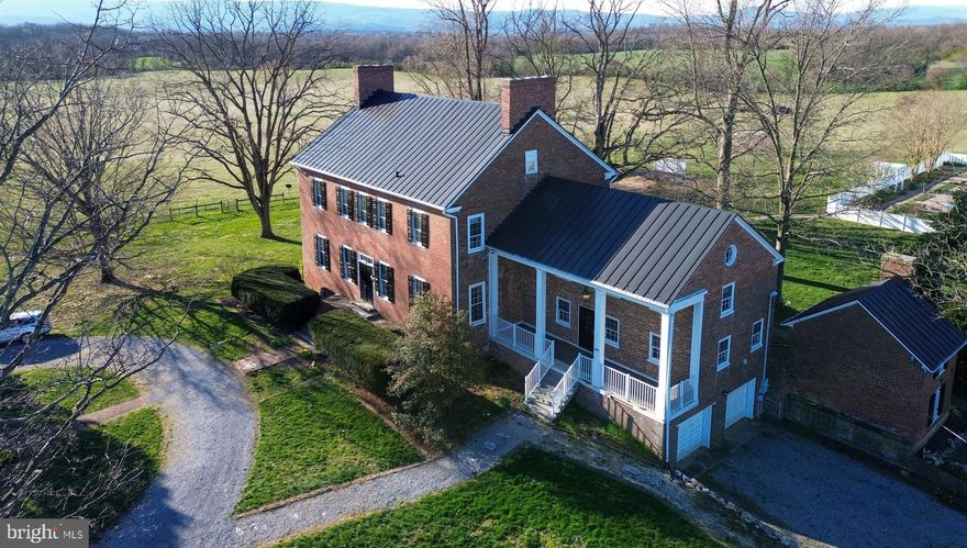 Just 70 miles west of DC, in Virginia’s scenic Shenandoah Valley, lies "Lucky Hit," a most beautiful and historically significant country estate believed to be the area's first brick mansion.  It is beautifully situated on 30 acres (additional land available) of rolling fields framed in the distance by the Blue Ridge Mountains. This beautiful Federal home offers over 8,000 sq.ft. of living space including 5,282 sq.ft. above grade, a finished basement, sunroom, 5 spacious bedrooms, 4.5 baths, and 8 fireplaces.  The kitchen was remodeled in 2000 with cherry cabinets, Corian / granite counters, and large pantry. At the back of the house, a spacious sunroom overlooks the beautiful backyard and the wonderful pool area that will be the hit of summer complete with heated pool, spa, and spacious patio with an arbor and pergola for shade.  The property also features a bank barn (recently used as a wood shop and art studio), pole barn, and fenced pastures.