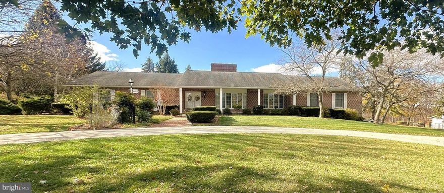 This 1 story spacious all brick home with 3 bedrooms, and 3 full baths on the main level features beautiful random width oak floors throughout.  You’ll find solid cherry kitchen cabinets with cathedral arch doors, and under cabinet lights which highlight the Granite countertops and breakfast bar area.  The 3-basin kitchen sink has a window overlooking the fenced in rear yard and part of the large horse pasture.  There are two fireplaces, one in the formal living room and an all brick one in the main level family room.  Enter the front door into a hallway with chandelier lighting, other rooms include a formal dining with chandelier, 24’ x 24’ music/library, 12’ x 15’ office, and main level laundry.  You access this 36-acre private setting from a blacktop driveway leading to the large circular paver driveway in the front of the home.  The lower level of the home includes a 10’ x 15’ wine cellar, a 15’ x 31’ tiled & heated with many cabinets rec room, 4’6” x 19 custom cedar closet, and 2 areas for workshops.  The home includes 2 heating systems with central air, consisting of 2 electric heat pumps with backup propane, including 200 Amp electric service, a Timberline architectural roof and a 2-car attached garage.  The exterior includes: 7’ x 39’6” covered front porch, 12 x 17’6” covered rear porch with railing, Honeywell auto generator, 11’ gazebo with seating, and a 72’ x 32’ barn. The barn with several acres of pasture has a brick hallway and includes 5 stalls – one with a door to the pasture, heated office with private entrance, hot and cold water, generator hookup, 2 large sliding doors, and a large feed bin.  There is a 2nd outbuilding also accessing the pasture, 36’ x 20’ with 11’ x 6’ sliding door and hinged entrance doors.  There are 2 wells on the property, 1 for the house and 1 for the barn.  Included with the property: Refrigerator, built in electric cooktop, 2 built in ovens, built in Jenn Air microwave, dishwasher, washer and electric dryer, window coverings and area rugs on some floors.