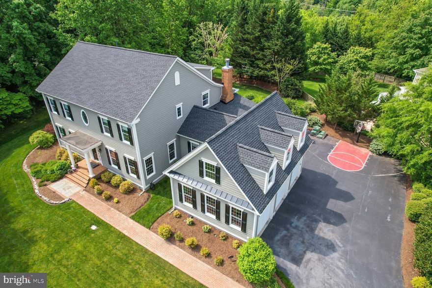 Price adjustment-Welcome to the niche neighborhood of Chapel Bridge Estates. . Pride of ownership is evident  on every level. 10 ft Ceilings on Main floor, 9 ft everywhere else.  New  Smart Roof 01/22, New Furnace 12/22 This 2002 home is a quiet stunner.  Pristine and custom built , 2 story home offers 6800 beautifully finished square feet with seven bedrooms, and 4.5 bathrooms.  Situated on a .68 acre, quiet, cul-de-sac lot, not a detail was overlooked when designing this beautiful abode. An Executive stye, MAIN FLOOR primary suite featuring extensive wainscoting, thick crown molding, floor to ceiling built-ins, and transom windows, all lend to the the air of elegant, yet livable, sophistication.  The long drive leads to the side load 3 car oversized garage with tons of storage.  The custom brick sidewalk ushers your guests to the front door of this lovely center hall colonial.  You will be wowed by the size of the foyer, the beautiful arched entries to elegant rooms with bespoke moldings, soaring ceilings, miles of gleaming hardwoods, and one of a kind light fixtures.  The large living room is light filled and perfect for after dinner coffee while listening to your favorite pianist on the grand piano.  Across the hall is the breathtaking dining room.  Serve a crowd around the banquet sized dining table.  Many beautiful windows grace this elegant room.  On the left of the wide center hall is the half bath, large coat closet, and the Primary Suite.  French doors lead to a small foyer, on the left is a dedicated office, and to the right is the king sized bedroom.  Built ins, hardwoods, moldings, beautiful windows, and his and hers walk-in closets are all part of the suite.  The ensuite has two separate vanities, a separate shower, and a spa like soaking tub.  Back to the center hall, at the rear of the home, is the family room.  This room was designed to have large open areas, with small sitting and lounging places.  The gas fireplace and the built in shelving make this exceedingly large room feel intimate and cozy.  There are two sets of French doors which lead to the wide back porch.  The kitchen sets the tone for the home, as it has plenty of room to eat in at the table for six, sit at the bar, or lounge with a cup of coffee in the little nook.  Entertainers will appreciate the two pantries, tons of storage, Miele and Profile appliances. The Profile Refrigerator matches the beautiful linen white custom cabinets.  The double wall ovens feature convection as well as standard options.  A five burner stove with grill make cooking for a crowd a breeze.  Meal prep can be done by everyone at the kitchen island which features a vegetable prep sink and on tap filtered water.  The Florida room is right off the kitchen and offers an additional 200 sf for a quiet morning breakfast while enjoying the beautiful landscaped back and side yards.  At the top of the ample staircase, there is a delightful library with a spider web window, a ton of windows, and of course, miles of book shelves so you can while away the days, reading a book or working on your laptop. Five bedrooms upstairs.  Bedroom 1 and 2 feature large closets, beautiful windows, and are connected by a well appointed Jack and Jill bathroom.  Bedroom 3 and 4 are also very large.  A special feature is the window seat and sweet lighting.  The Jack and Jill helps keep mornings running smoothly for everyone.  Bedroom 5 has windows all along the back wall and a  huge walk in closet.   The laundry room is on the bedroom level, keeping home maintenance to a minimum.  A truly massive finished basement is a wonderful part of this executive home.  Possibilities abound! The Flex space could be used for a theater or as an addition to the gym for yoga.  The den, full bath and 7th bedroom offer guests a place to unwind after a day touring the city. Basement FP doesn't work.  Don't forget all of the additional storage in the unfinished part of the basement. Commuter's dream!