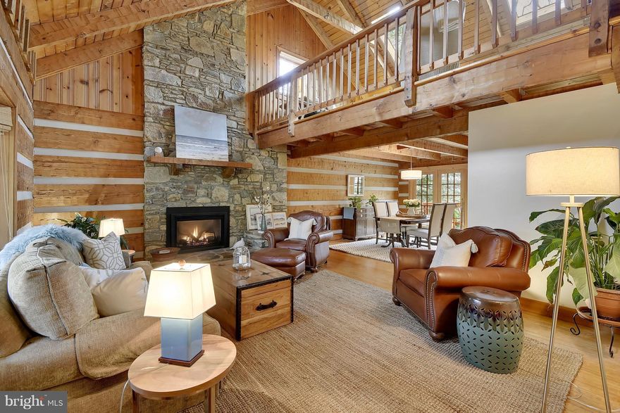 Rough hewn Georgia Pine stick custom built LOG CABIN that is one of a kind gorgeous but full of character with soaring ceilings & open delightful floorplan-killer kitchen w/double ovens, convection oven & granite island-dining area-3 family room areas w/FP & one of my favorite spots-recent oversized front porch large enough for a party. Quiet dead-end comm  & avail boat slips! OPEN SUN 29th 10-12