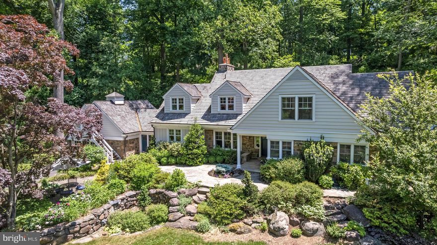 Set on approximately 7 acres in the estate section of Villanova, this one-of-a-kind property offers a rare combination of space, privacy, and flexibility—just minutes from the heart of the Main Line and Center City Philadelphia. Thoughtfully renovated in 2014, the home balances modern comfort with timeless design.
The main residence features a spacious first-floor primary suite with dual bathrooms and generous closet space. Upstairs are three additional bedrooms and two bathrooms. Above the attached two-car garage is a large studio apartment with a private entrance—ideal for guests, an au pair, or a dedicated work-from-home setup.
The open-concept kitchen and dining area feature vaulted ceilings with illuminated beams and lead into a bright, spacious living room, offering a seamless layout for both everyday living and entertaining.
Step outside and enjoy beautifully landscaped grounds designed to enhance the natural surroundings. Several terraces overlook ponds, waterfalls, and wooded views—offering peaceful spots for outdoor meals, coffee, or gatherings. Gardeners will appreciate the dedicated vegetable, herb, and perennial beds, while nature lovers will enjoy the hundreds of native trees and shrubs planted throughout the property. A private walking trail winds through meadows, woods, and hills.
Adding to the property’s appeal is a two-story barn, originally built in Canada circa 1865 and carefully reconstructed on-site in 2015. This barn serves as a focal point, offering rustic charm and versatility. Currently used for equipment storage and a workshop, the barn has potential for conversion into a guest house, gym, car collection space, or entertaining area.
This home offers a unique opportunity to enjoy natural beauty, quiet seclusion, and modern convenience—all within close reach of top-rated schools, shopping, dining, and transportation.
Schedule your private tour today.