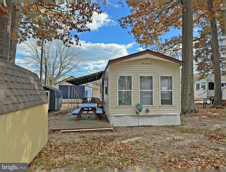 SEASONAL SITE - April 15 through November 15. Sea Air Village is the closest RV Park to the Rehoboth boardwalk & beaches (approx. 2.5 miles). And if you don’t feel like driving to the beach, the DART bus (201 line) has a stop near the community entrance at the IHOP restaurant. If you feel like staying close to home, Sea Air has two pools - a standard pool and a “wading” pool. They also have a community center, a pavilion, a playground, and basketball courts. There's a dog park for your 4-legged friend, too.  This cozy Park-model manufactured home is just adorable!  It is approximately 12’x28’. The spacious living room, with a vaulted ceiling, opens to the galley kitchen & dinette area. The kitchen has a breakfast bar, a new range (2025), range hood, countertop microwave, and a Frigidaire refrigerator with a freezer. The dinette area features a bay window. The bedroom, which also has a vaulted ceiling, is to the rear of the home. It has a double closet & built-in drawers. The home has a full bath with a tub/shower, single-sink vanity & standard-size toilet. For your convenience, there is a stackable ASKO-brand washer & dryer in the hall next to the pantry/utility closet. Central vac to catch any sand from the beach. Open and covered (metal roof) deck so you can relax after a day on the beach or at the pool. Newer shed. Newer 2023 roof-mounted HVAC. Water & sewer are included in the Lot Rent; Homeowner pays electric (Delmarva Power) and fuel (LP gas). Discounted seasonal cable packages are available from Comcast/Xfinity & WiFi is also available if you’d rather stream. Boat and PWC vehicles are permitted to be stored on the lot if pre-approved by the Park manager. Sea Air Village requires the Buyer to apply for acceptance as a resident (all adults 18-years-of-age or older must apply). Acceptance is based on income verification, credit bureau check & a criminal background check. Closing cost will include a 5.25% Delaware DMV Title Fee.  Seasonal fee for 2026 is $6,130.