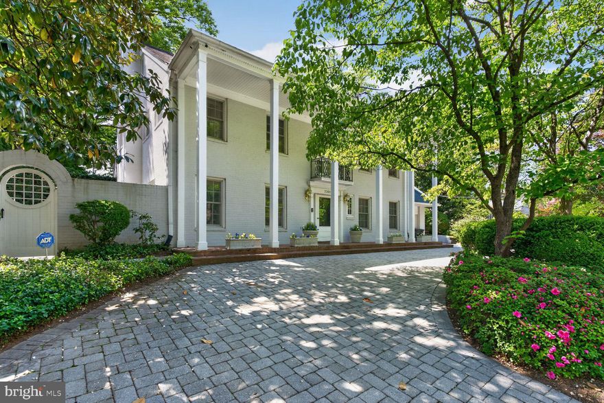 Graceful columns introduce this Georgian Colonial residence, beautifully maintained and sited on a generous 1/3-acre, (double) lot with fabulous Pool, and offering nearly 5,000 total square feet.  
The entry level offers exceptional flexibility, highlighted by its beautiful living room with custom built-in shelving and direct access to a charming courtyard garden,  a second kitchen and casual dining area, and a room that can serve as a bedroom or library with a fireplace, along with a full bath.
 This level also provides direct access to a two-car garage, enhancing both convenience and functionality.  
The second level features a second gracious living room, or formal dining room, adjacent to a lovely sunroom connecting to the well appointment kitchen and dining area with direct access to the large brick rear patio, with trumpet vine-covered pergola, 15x32 pool and a stunning Lila Fendricks-designed back garden—private and perfect for effortless indoor-outdoor living. 
A separate family room on the main floor has a dramatic vaulted ceiling and huge window adding warmth with immense architectural interest, inviting gathering and relaxation. Plus a full bath
The expansive primary suite offers a private retreat, complete with office or sitting room and fireplace, lovely bedroom and petit balcony, dressing area, and a fully appointed bath including a steam shower. 
3 additional bedrooms and baths provide ample space for all occupants & guests!
This is a "must see" property!