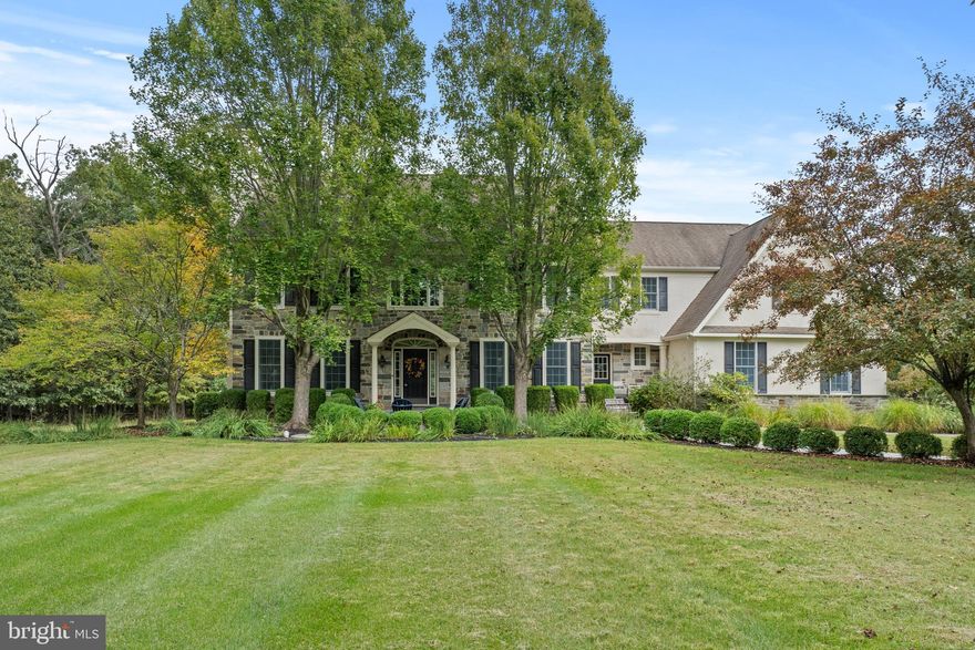 Offered for the first time, is this real stone front home in Ashbourne estates, which is located on a premium lot.  As you walk in from the tree lined driveway, onto the flagstone walkway, take notice of the extensive landscaping that has been done.  Upon entering the foyer, the grand two story entry welcomes you to the left, with a gas fireplace in the formal living room.  Make sure to take notice of the upgraded Emtek door hardware as you walk in, that is located throughout the home.  The main stairway is in front of you.  The home office is to the back left and there is a powder room conveniently located there as well.  If there is no need for an office, the space could be used as you see fit.  To the right is the formal dining room with a tray ceiling.  This entire area has solid hardwood flooring and three piece crown molding.  Head to the back right into the kitchen, where there are upgraded appliances, custom moldings and a tiled backsplash.  The eat-in kitchen dining area overlooks the backyard and has a cathedral ceiling.  Adjacent to the kitchen is the family room which has a custom built-in entertainment center, wood burning fireplace, and a cathedral ceiling.  Also found on this floor, is a mud room with wainscoting, a second stairway and an additional powder room.  At the top of the back stairway, is a nautical, themed room.  Here you will find a hardwood floor that  appears like you are on a ship deck.  There are built ins, a bonus room and a loft with boat accents.  Then next door down on the left is another bedroom.  This room has white oak floors with wainscoting, crown molding and pink toile wallpaper.  These two room are conveniently connected by a jack and jill bathroom.  Across the hall is a guest bedroom complete with an ensuite.  Next door to that bedroom is the laundry room.  Continue down the hallway and you will end up at the main bedroom, after crossing over the foyer below.  Inside the double door opening is a spacious bedroom with a tray ceiling.  The ensuite has a large shower, soaking tub, double vanity and large walk-in closet.  The basement has an upgraded, large walk out and tall ceilings, just waiting to be finished however you imagine it.  The back yard is almost 2 flat acres and is ready to be made into your personal oasis.  The home also has the light package, which places an outlet below each of the windows across the front of the house and has a switch located in the main bedroom.  Come and see all this home has to offer!  Professional photos coming Tuesday 9/23