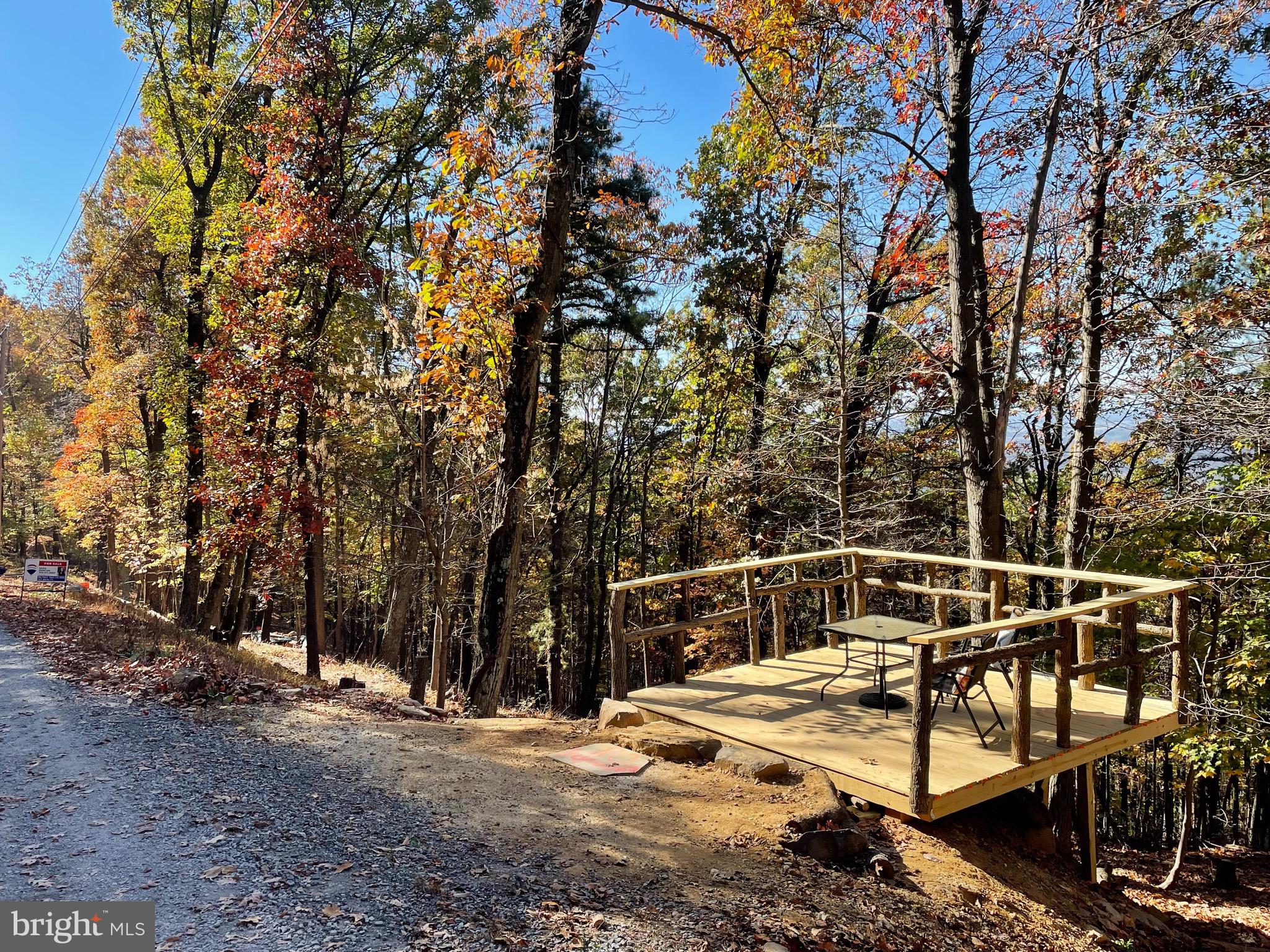 Discover a great opportunity to own an improved lot in Harpers Ferry that offers a 180 degree long range sunset view of the Shenandoah River, Charles Town, and Blue Ridge Mountains! It is the perfect location to get away from the hustle and bustle of a crazy work week. Located in a wonderful location for tranquility and peace while you enjoy the beauty of nature and wildlife around you. Hiking trails nearby also! Seller built a brand new beautiful platform on the parcel to help enhance your camping experience!