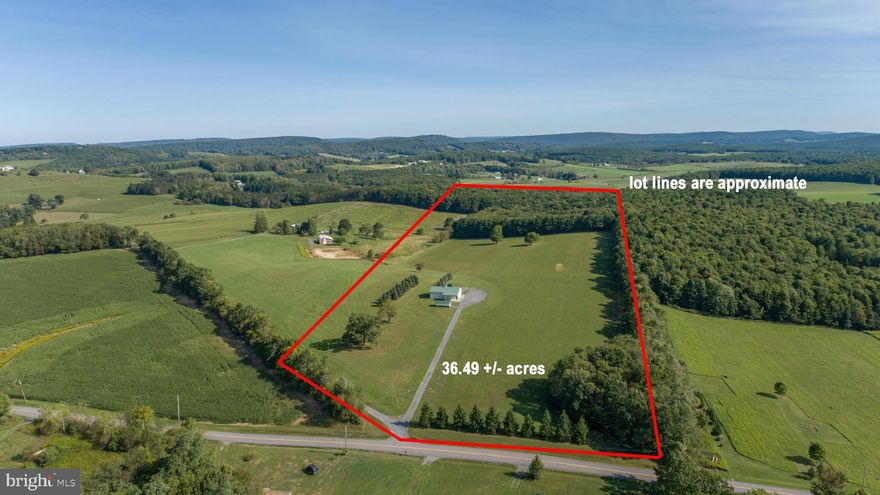 Remarkable opportunity!  Located conveniently between the lake and Oakland, this 36.49 acre property offers rolling land with a mixture of pasture and woods including 5 approved perc sites.   Improvements include a 60' x 40' pole building with 14' ceilings and two 12' garage doors.  The building has water and septic access, great electric service, a full bath, heated ceilings, abundant lighting, connections for you RV and or travel trailer,  and a 30' X 12' attached car port.   A separate 1 car garage is close by.  

The level entrance gravel drive off Spring Glade Road is easily accessible in all seasons.    The property has been prepared for a future residence and or additional buildings.   The wooded area offers trails and several springs with plenty of wildlife frequenting the property.
