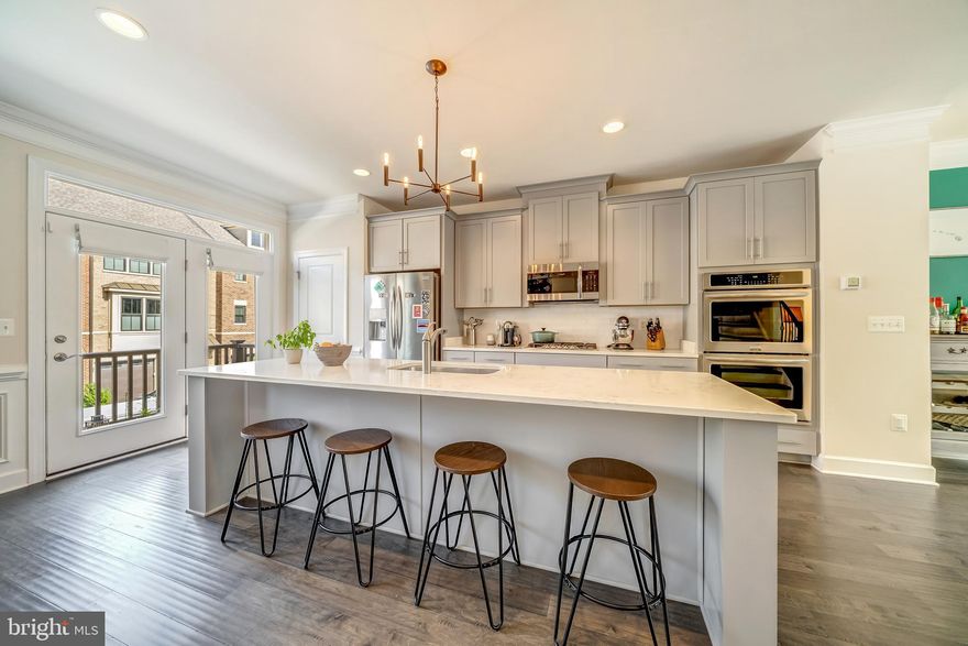50K Price Reduction! Why wait for a new build? Move-in ready Modern like new construction with upgraded high quality finishes throughout. Built in 2018, this 4 bed, 2 full bath, 2 half bath, 4 level town house which spans 2,299 sq ft, is tastefully designed for the urban living lifestyle. Be prepared to be wowed by your expansive gourmet kitchen with oversized island, quartz countertops,  stainless steel appliances, architectural backsplash, luxury shaker cabinets, and high end hardware which complete the entertaining centerpiece of this home. The generous open floor plan, high ceilings on 4 levels, and natural light throughout create the feeling of tranquility. From the large primary bedroom with en-suite and his/her walk-in closets to the spacious second and third bedrooms, no room has been spared of size and elegance. Rounding off your urban oasis is a palatial roof deck a private sanctuary for parties, relaxing, or gazing at the stars. Highlights include an upper level 2 loft and lower level workout room or office, crown molding and wainscoting on all levels, upgraded hardwoods, oversized garage with ability to park two SUVs comfortably, designer wall paper, and much more. Ambrose Hill HOA maintains all common area and lawn care. Enjoy quick and easy commuter access to Columbia Pike, Arlington, DC, Amazon HQ2, Tyson's, and Reston's Tech corridor. Metro stop, restaurants, stores are conveniently located mins away. Your urban oasis awaits!