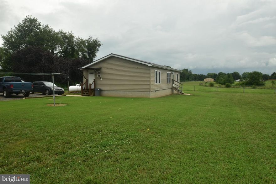 Welcome to 263 Smoky Lane, Smyrna, DE – a private, peaceful retreat situated on an impressive 13.7-acre lot! This well-maintained 3-bedroom, 2-bathroom mobile home offers a rare blend of rural charm and modern updates. Set back 400 feet off the road on a secluded private lane, you'll enjoy quiet country living with room to expand, garden, or simply enjoy the outdoors. Recent updates include a new tin roof (2014), new energy-efficient windows, and upgraded insulation for year-round comfort. The home also features a septic system, a security system, and three outbuildings for all your storage or workshop needs—including an oversized 30’x40’ shed with its own well water and electric service—perfect for a hobbyist, contractor, or small business owner. Whether you're looking for a private homestead, a hobby farm, or an investment opportunity, this property offers space, functionality, and potential. No HOA, plenty of room for animals, ATVs, or simply enjoying the great outdoors. Don’t miss this unique opportunity—schedule your private tour today!